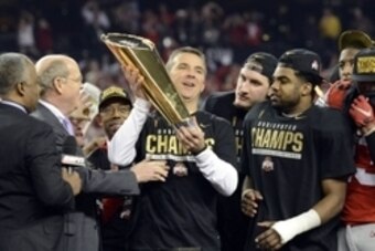 Jan 12, 2015; Arlington, TX, USA; Ohio State Buckeyes head coach Urban Meyer celebrates with the college football championship trophy after beating the Oregon Ducks in the 2015 CFP National Championship Game at AT&T Stadium. Mandatory Credit: Tommy Gillig