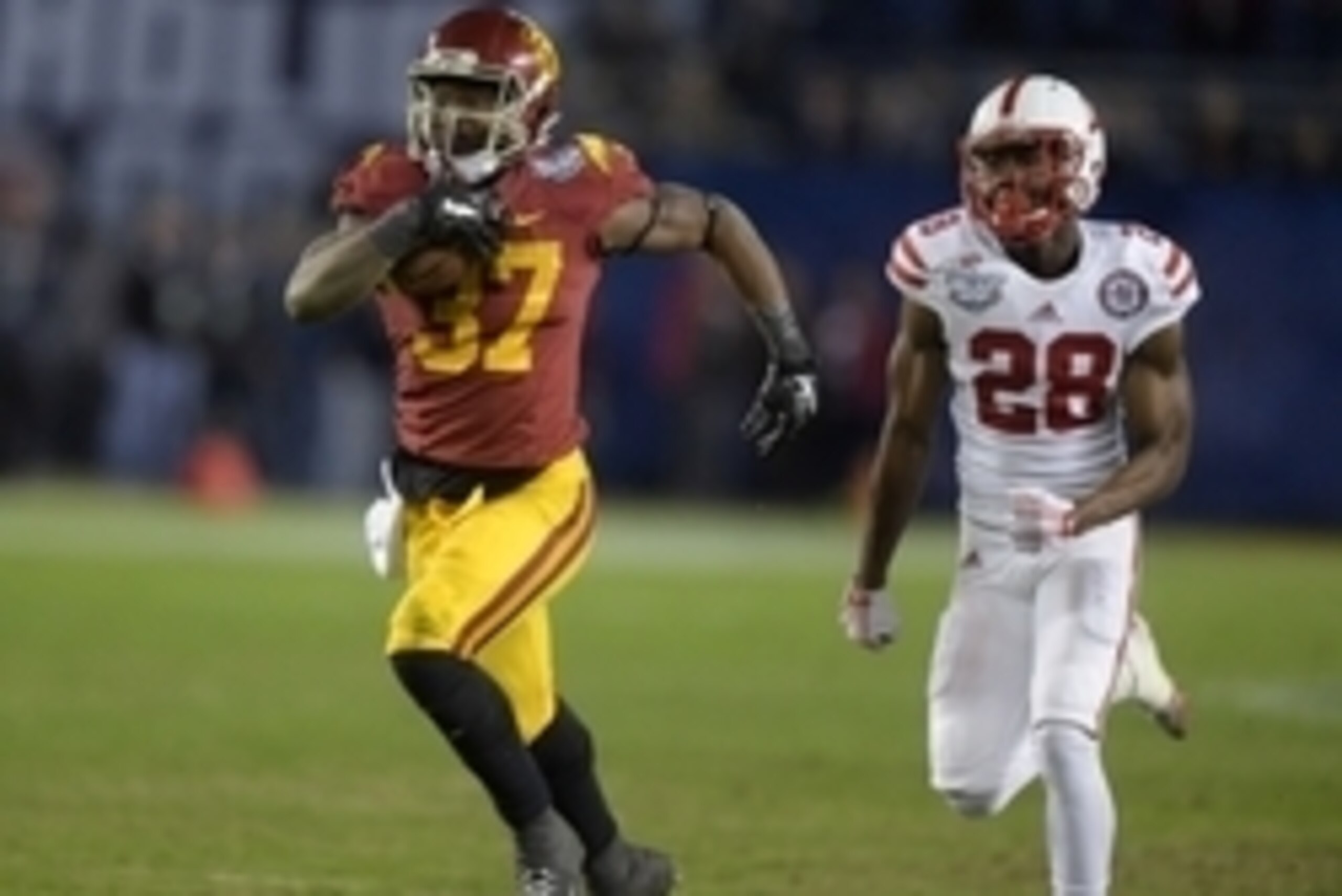 Dec 27, 2014; San Diego, CA, USA; Southern California Trojans tailback Javorius Allen (37)  is pursued by Nebraska Cornhuskers linebacker Austin Williams (24) on a 44-yard touchdown run in the third quarter in the 2014 Holiday Bowl at Qualcomm Stadium. Ma