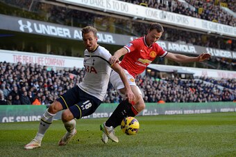 LONDON, ENGLAND - DECEMBER 28:  Harry Kane of Spurs and Jonny Evans of Manchester United battle for the ball during the Barclays Premier League match between Tottenham Hotspur and Manchester United at White Hart Lane on December 28, 2014 in London, Englan