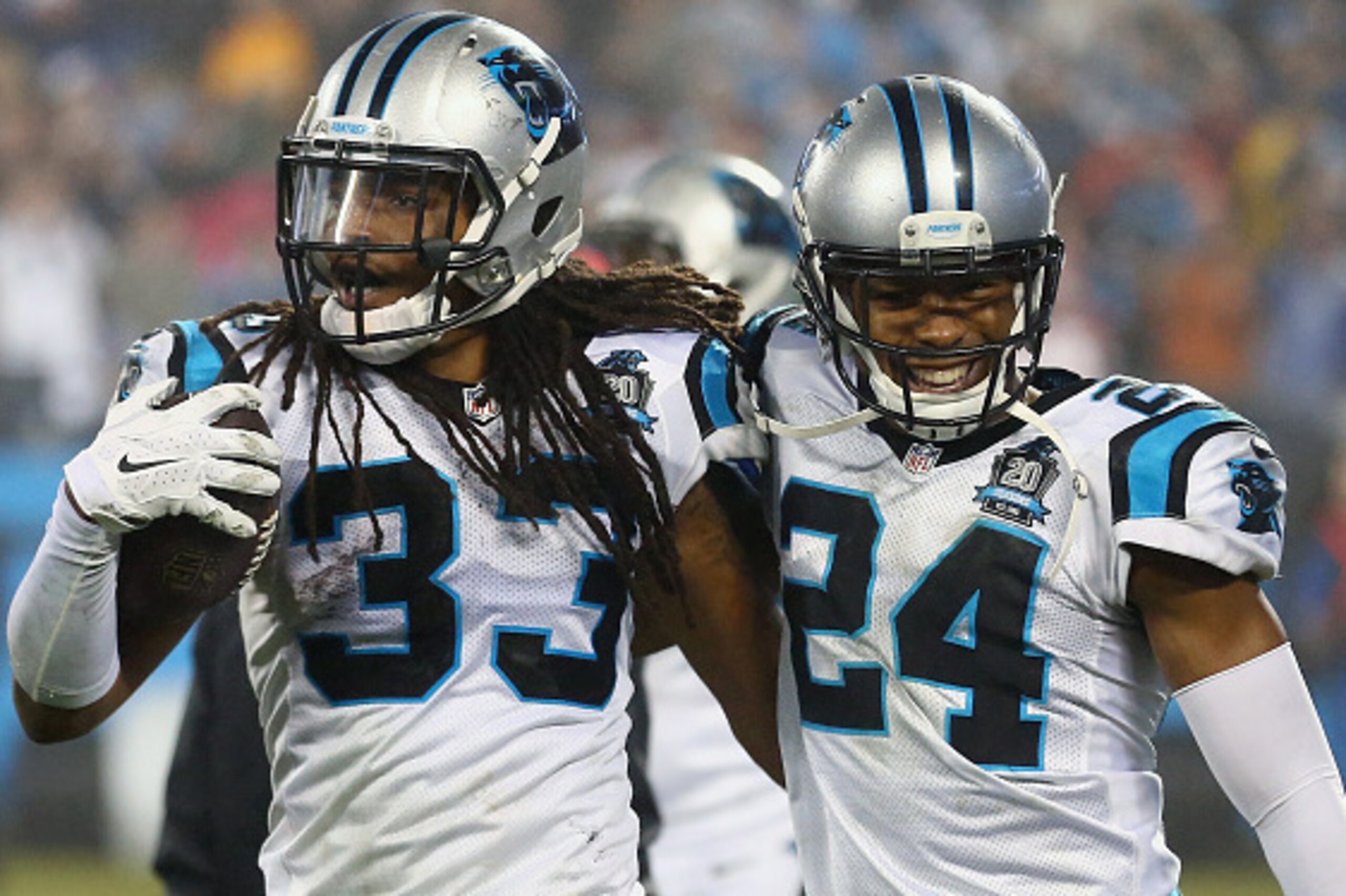 CHARLOTTE, NC - JANUARY 03:  Tre Boston #33 and Josh Norman #24 of the Carolina Panthers congratulate each other after their 27-16 victory over the Arizona Cardinals after their NFC Wild Card Playoff game at Bank of America Stadium on January 3, 2015 in C
