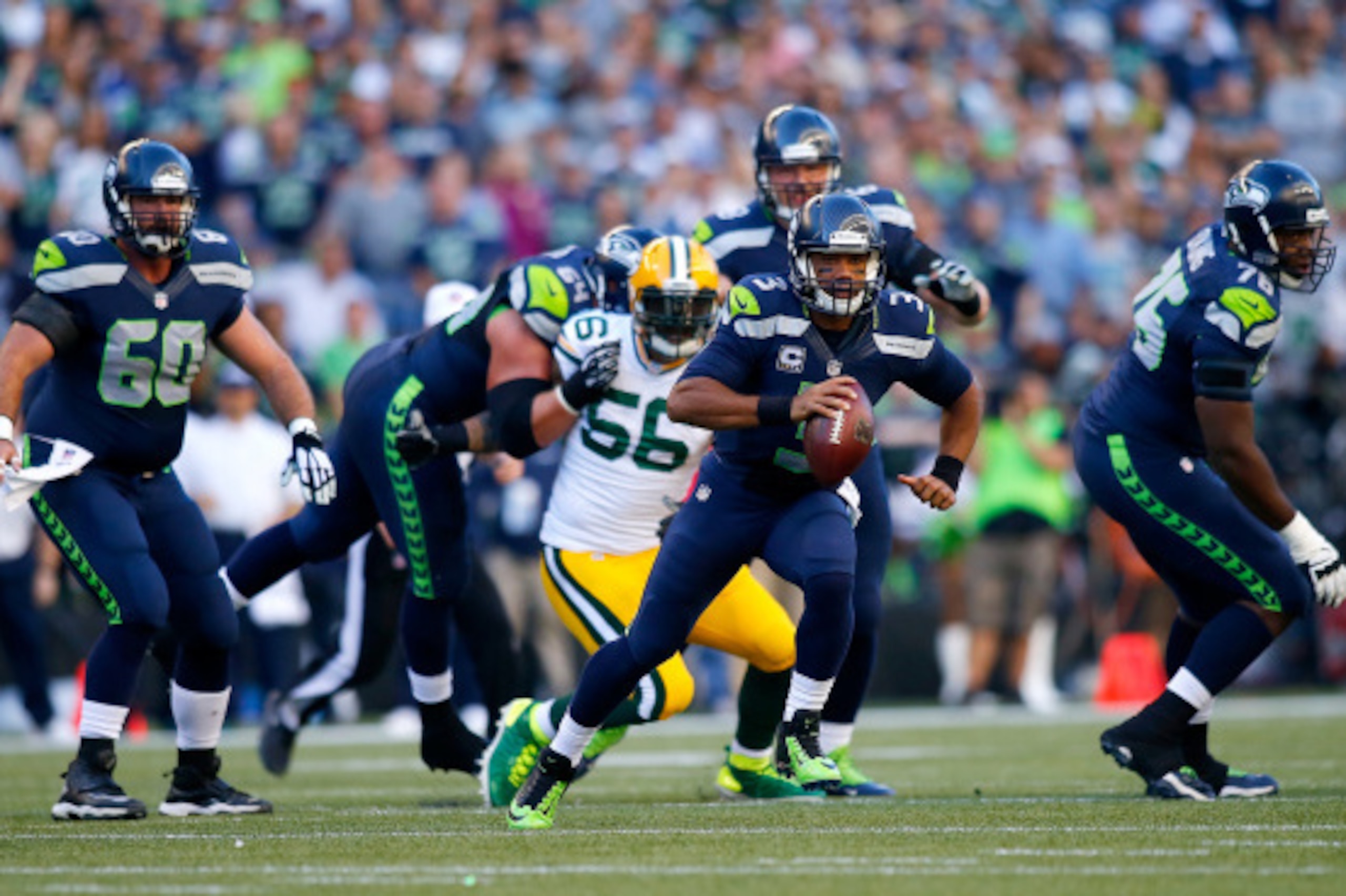 SEATTLE - SEPTEMBER 04:  Quarterback Russell Wilson #3 of the Seattle Seahawks runs with the ball against the Green Bay Packers at CenturyLink Field on September 4, 2014 in Seattle, Washington.  (Photo by Jonathan Ferrey/Getty Images)