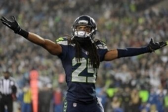 January 10, 2015; Seattle, WA, USA; Seattle Seahawks cornerback Richard Sherman (25) reacts after free safety Earl Thomas (29) intercepts a pass against the Carolina Panthers during the first half in the 2014 NFC Divisional playoff football game at Centur