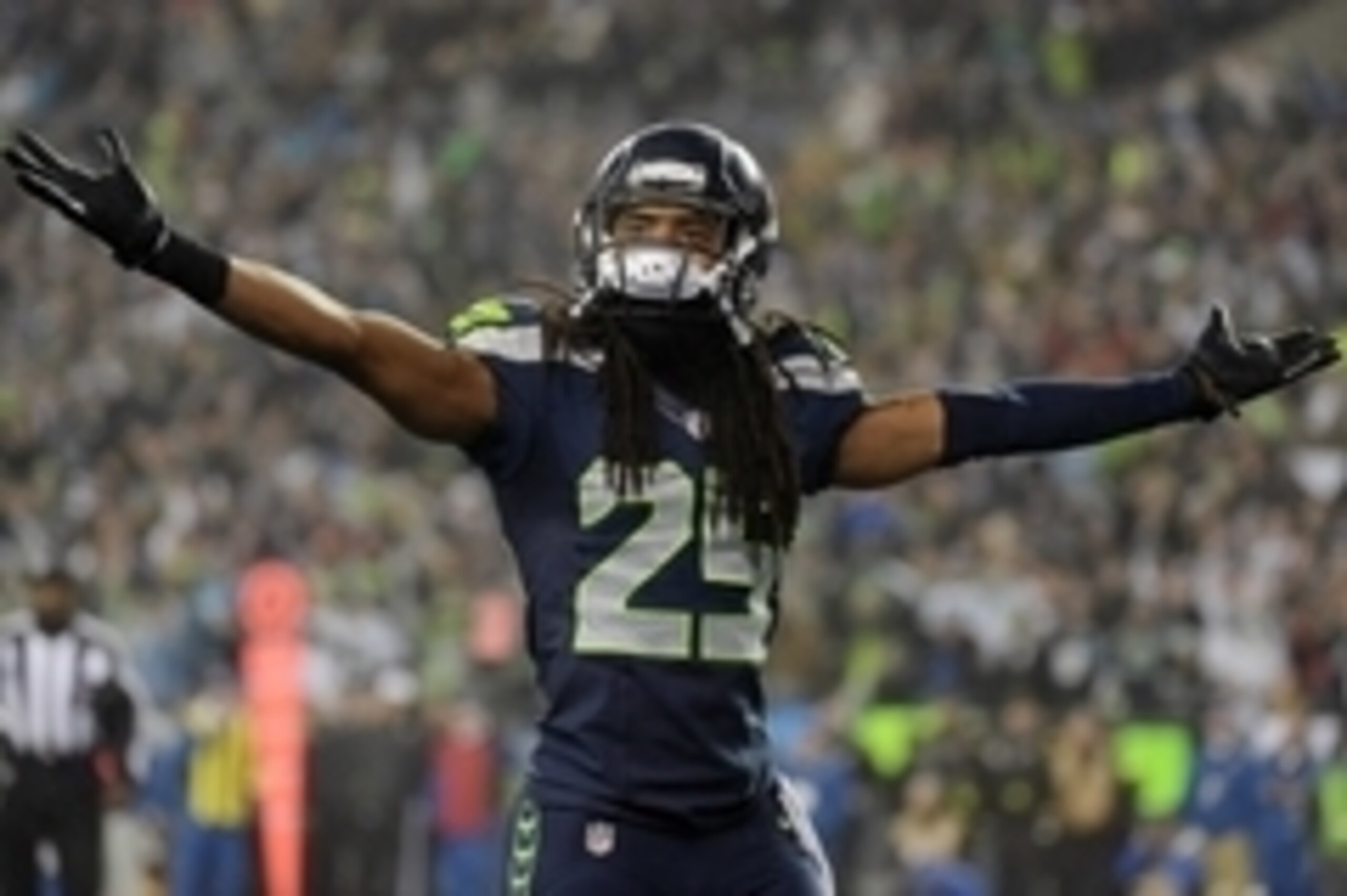 January 10, 2015; Seattle, WA, USA; Seattle Seahawks cornerback Richard Sherman (25) reacts after free safety Earl Thomas (29) intercepts a pass against the Carolina Panthers during the first half in the 2014 NFC Divisional playoff football game at Centur