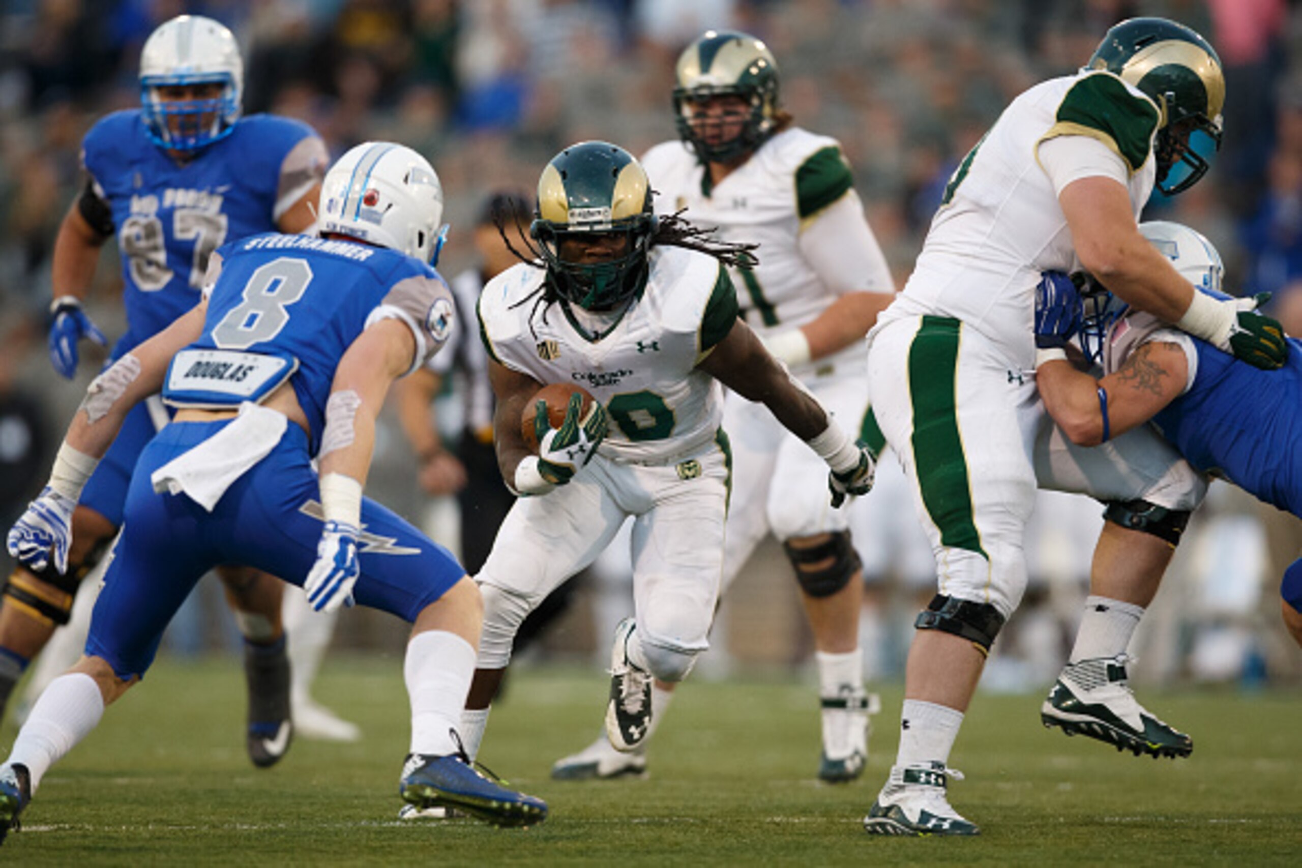 COLORADO SPRINGS, CO - NOVEMBER 28: Running back Dee Hart #10 of the Colorado State Rams runs through a hole before being tackled by defensive back Weston Steelhammer #8 of the Air Force Falcons during the third quarter at Falcon Stadium on November 28, 2