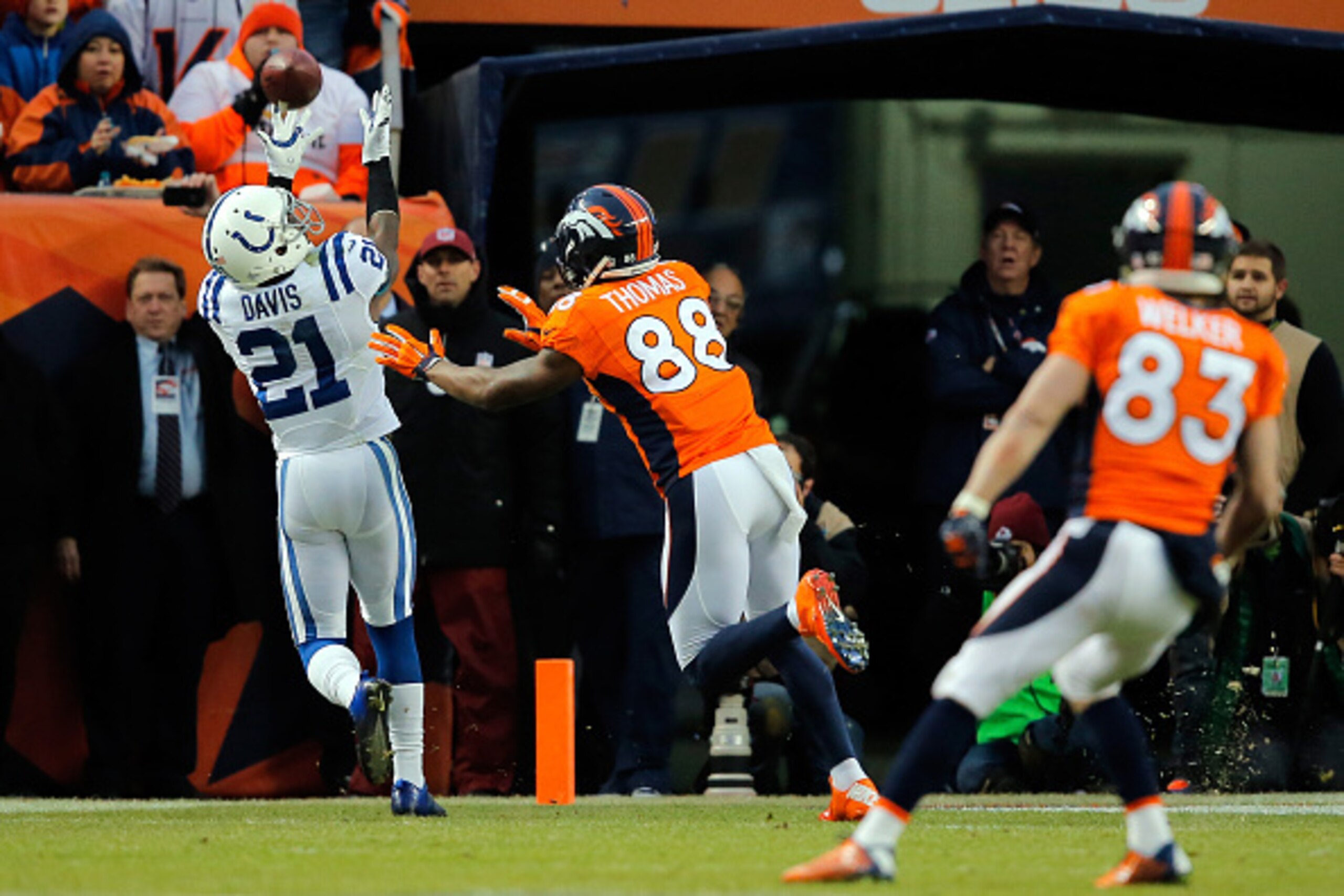 DENVER, CO - JANUARY 11:  Vontae Davis #21 of the Indianapolis Colts reaches for a pass intended for  Demaryius Thomas #88 of the Denver Broncos  during a 2015 AFC Divisional Playoff game at Sports Authority Field at Mile High on January 11, 2015 in Denve