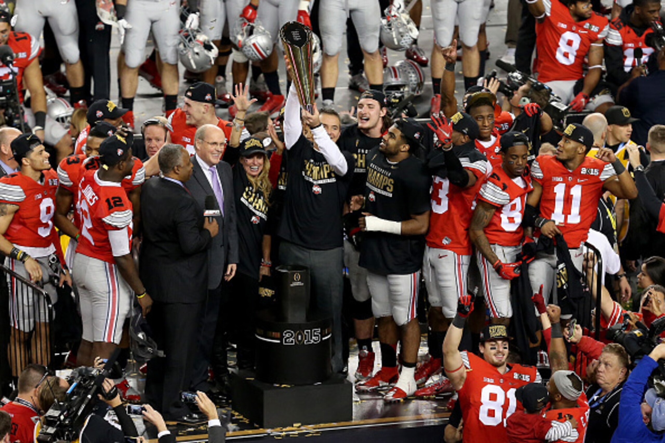 ARLINGTON, TX - JANUARY 12:  Head Coach Urban Meyer of the Ohio State Buckeyes hoist the trophy after defeating the Oregon Ducks 42 to 20 in the College Football Playoff National Championship Game at AT&T Stadium on January 12, 2015 in Arlington, Texas.  