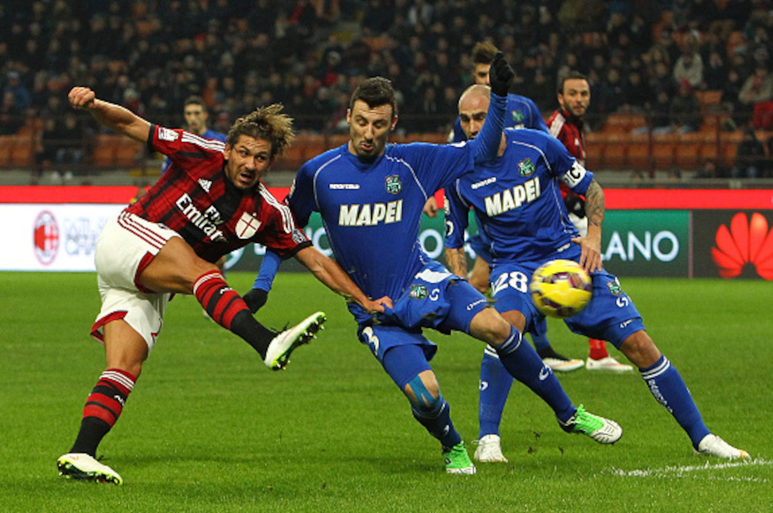 MILAN, ITALY - JANUARY 13:  Alessio Cerci of AC Milan is challenged by Alessandro Longhi of US Sassuolo Calcio during the TIM Cup match between AC Milan and US Sassuolo Calcio at Stadio Giuseppe Meazza on January 13, 2015 in Milan, Italy.  (Photo by Marco