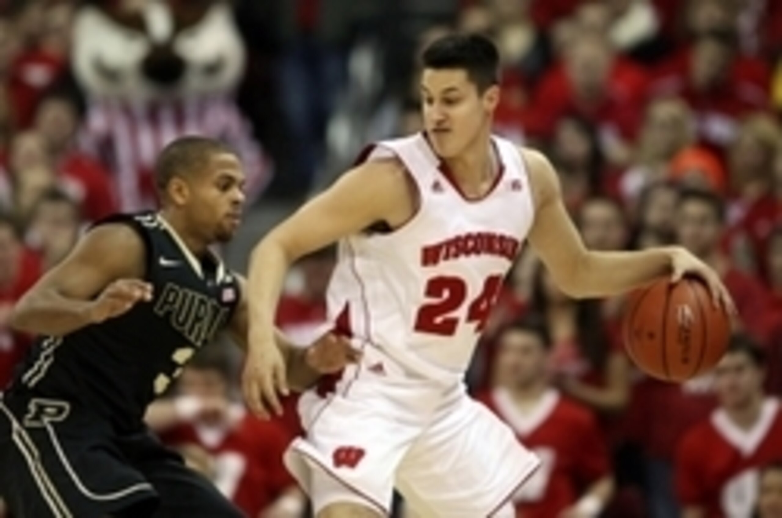 Jan 7, 2015; Madison, WI, USA; Wisconsin Badgers guard Bronson Koenig (24) attempts to move the ball around Purdue Boilermakers guard P.J.Thompson (3) during the first half at the Kohl Center. Mandatory Credit: Mary Langenfeld-USA TODAY Sports
