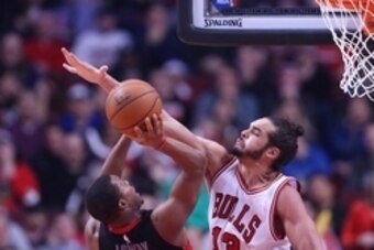 Dec 22, 2014; Chicago, IL, USA; Chicago Bulls center Joakim Noah (13) defends Toronto Raptors guard Kyle Lowry (7) during the second half of a game at the United Center. Chicago won 129-120. Mandatory Credit: Dennis Wierzbicki-USA TODAY Sports