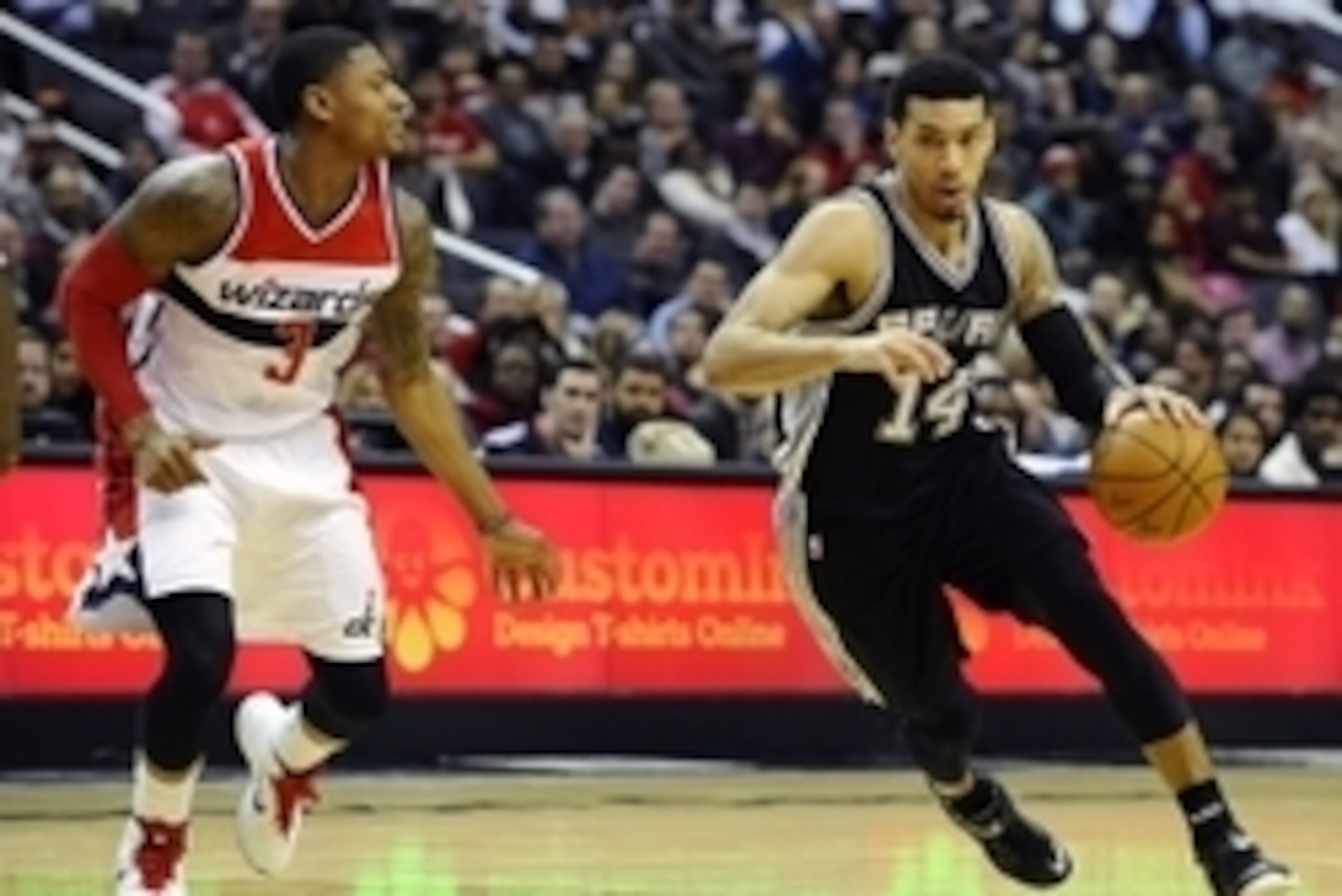 Jan 13, 2015; Washington, DC, USA; San Antonio Spurs guard Danny Green (14) dribbles the ball as Washington Wizards guard Bradley Beal (3) defends during the first half at Verizon Center. Mandatory Credit: Brad Mills-USA TODAY Sports