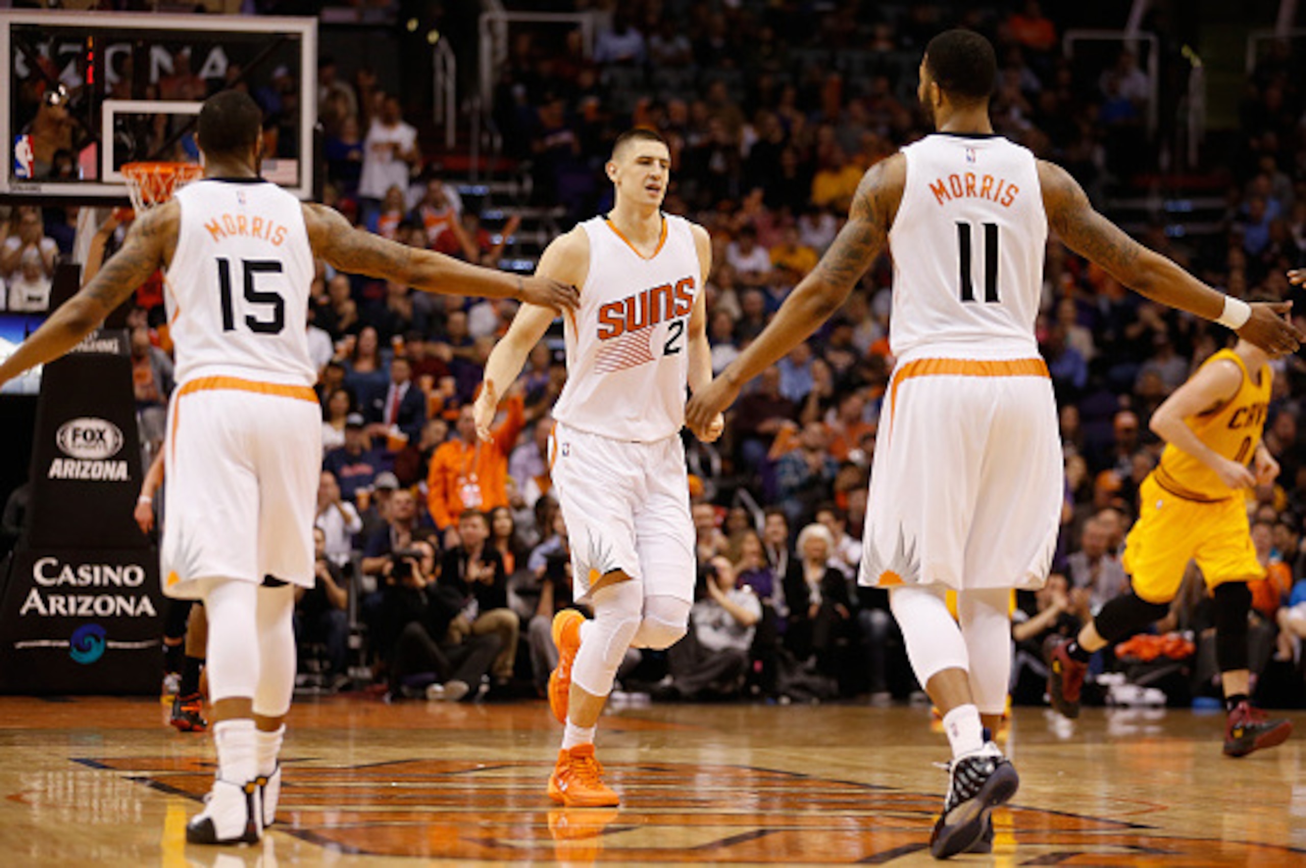 PHOENIX, AZ - JANUARY 13: Alex Len #21 of the Phoenix Suns high fives Marcus Morris #15 and Markieff Morris #11 of the Phoenix Suns after scoring against the Cleveland Cavaliers during the first half of the NBA game at US Airways Center on January 13, 20 PHOENIX, AZ - JANUARY 13: Alex Len #21 of the Phoenix Suns high fives Marcus Morris #15 and Markieff Morris #11 of the Phoenix Suns after scoring against the Cleveland Cavaliers during the first half of the NBA game at US Airways Center on January 13, 20