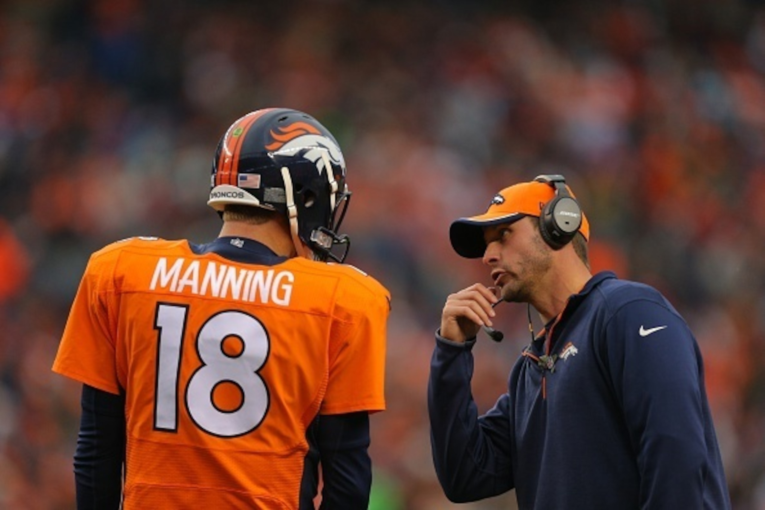 DENVER, CO - NOVEMBER 23:  Denver Broncos offensive coordinator Adam Gase has a word with Quarterback Peyton Manning #18 during a game at Sports Authority Field at Mile High on November 23, 2014 in Denver, Colorado.  (Photo by Justin Edmonds/Getty Images)