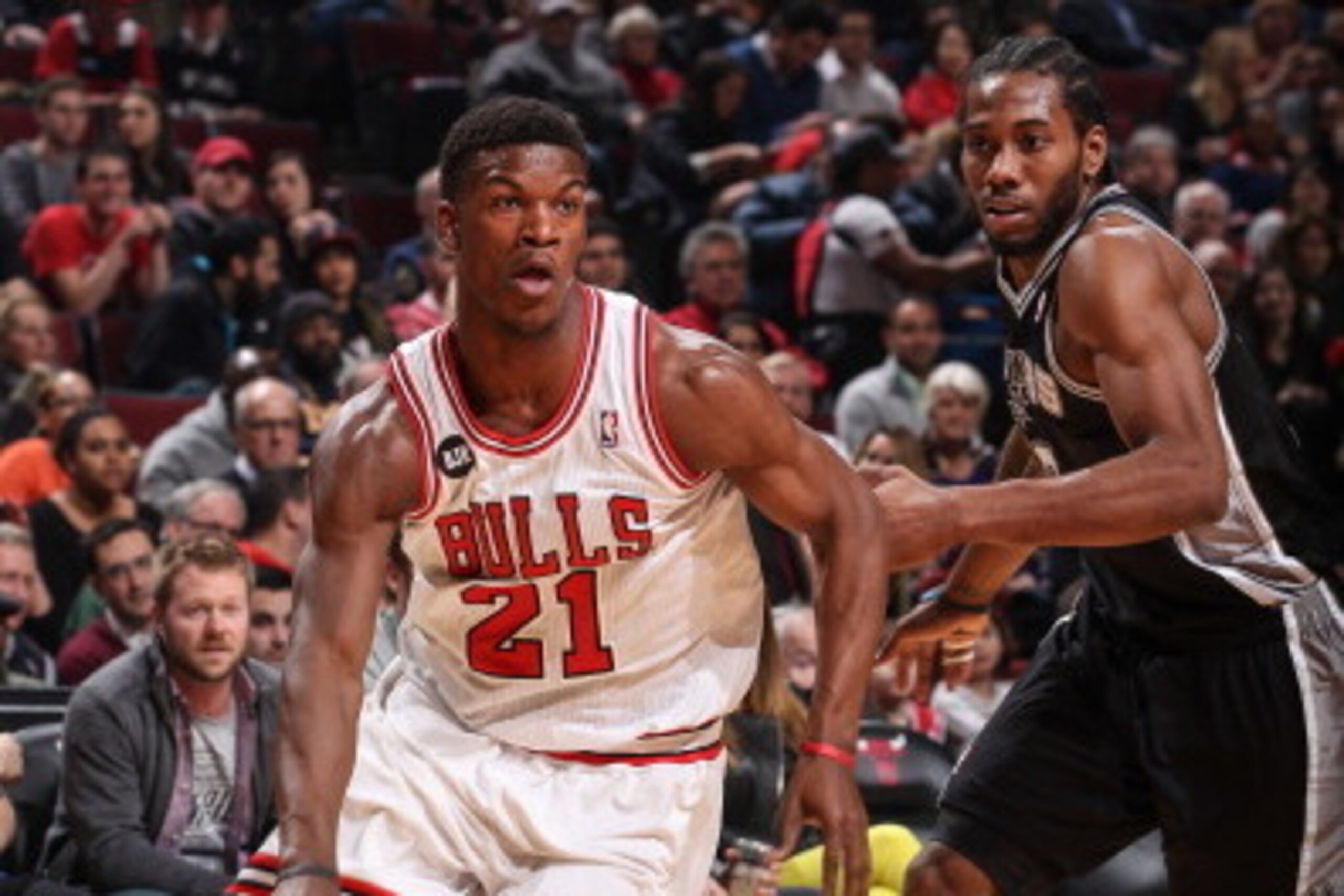 CHICAGO, IL - MARCH 11: Jimmy Butler #21 of the Chicago Bulls dribbles against Kawhi Leonard #2 of the San Antonio Spurs on March 11, 2014 at the United Center in Chicago, Illinois. NOTE TO USER: User expressly acknowledges and agrees that, by downloading