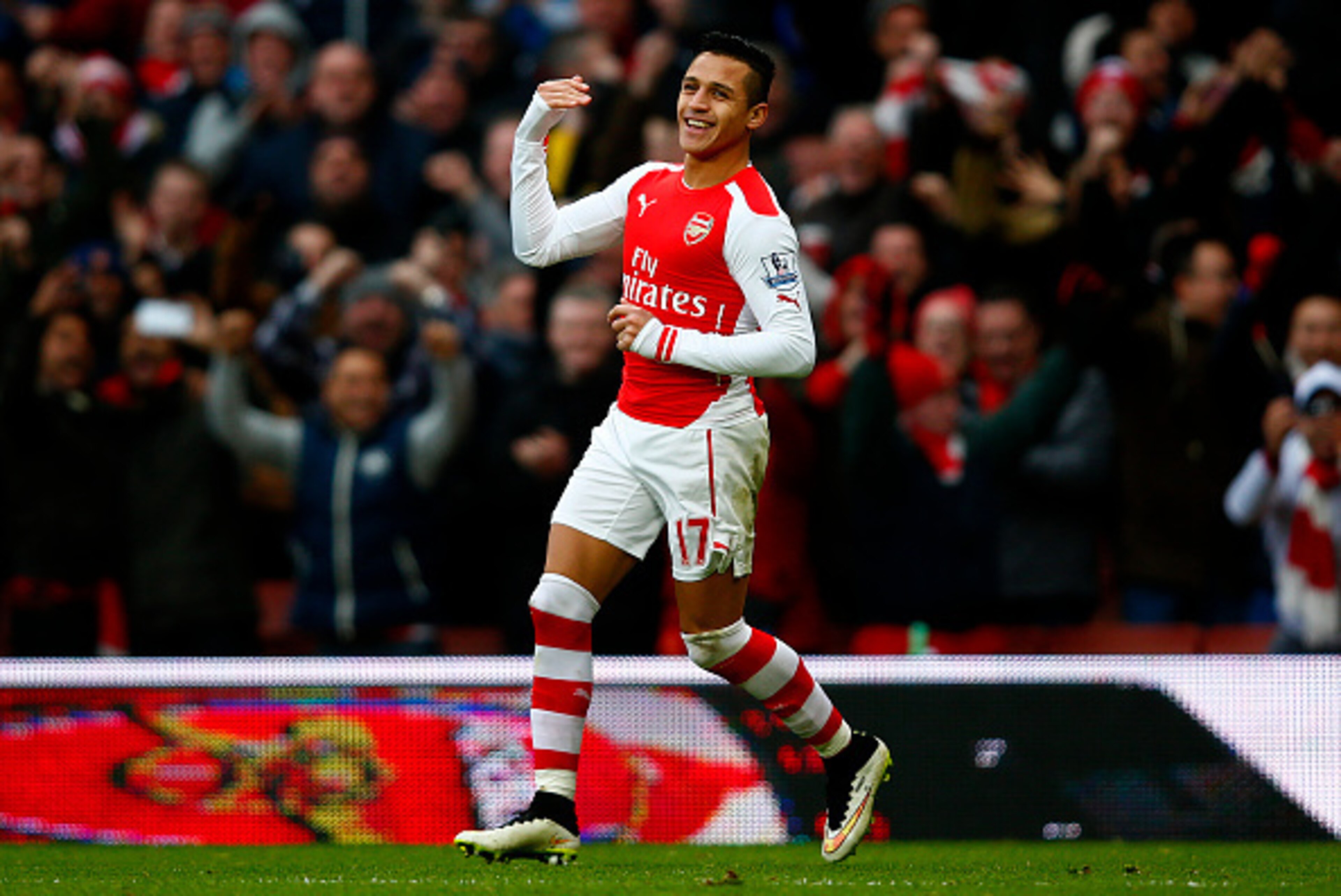 LONDON, ENGLAND - JANUARY 11:  Alexis Sanchez of Arsenal celebrates after scoring his team's third goal during the Barclays Premier League match between Arsenal and Stoke City at Emirates Stadium on January 11, 2015 in London, England.  (Photo by Clive Ro