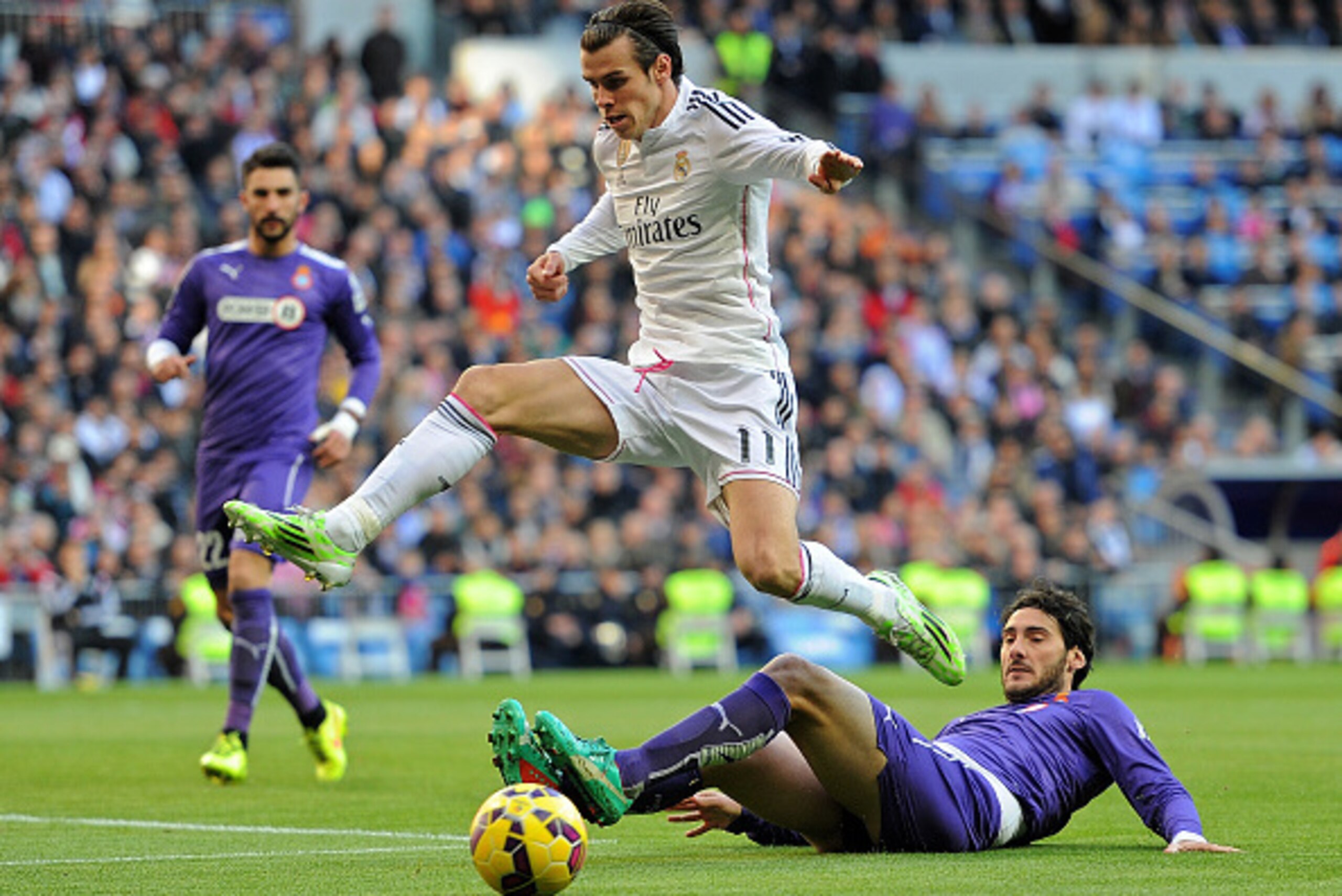 MADRID, SPAIN - JANUARY 10:  Gareth Bale of Real Madrid jumps over Anaitz Arbilla of RCD Espanyol during the La Liga match between Real Madrid CF and RCD Espanyol at Estadio Santiago Bernabeu on January 10, 2015 in Madrid, Spain.  (Photo by Denis Doyle/Ge