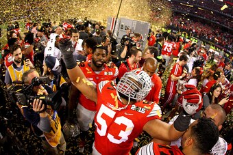 ARLINGTON, TX - JANUARY 12:  Defensive lineman Michael Bennett, wearing a #53 jersey in honor of fallen teammate Kosta Karageorge, of the Ohio State Buckeyes celebrates after defeating the Oregon Ducks 42 to 20 in the College Football Playoff National Cha