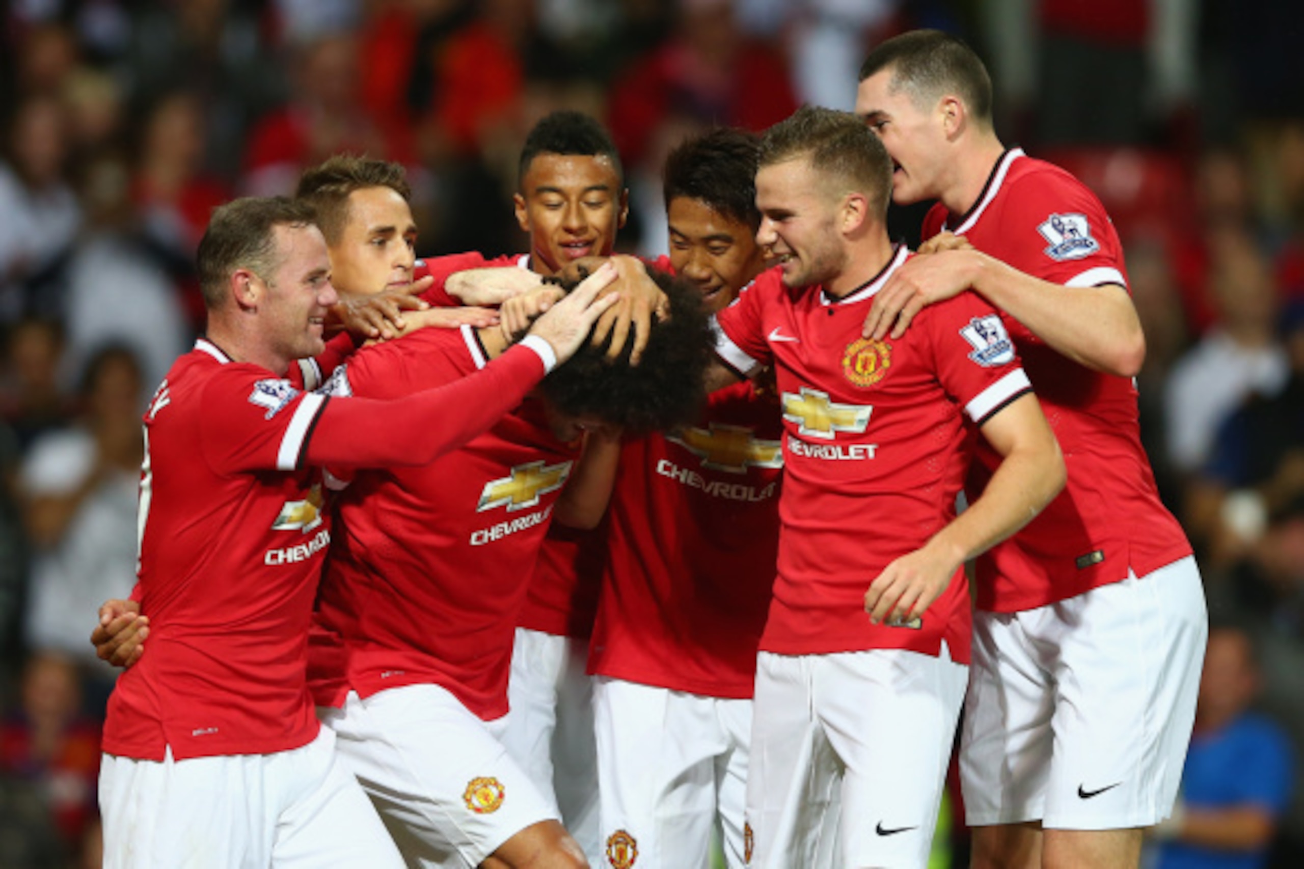 MANCHESTER, ENGLAND - AUGUST 12:  Marouane Fellaini of Manchester United is congratulated by team mates after scoring the winning goal in the last minute during the Pre Season Friendly match between Manchester United and Valencia at Old Trafford on August
