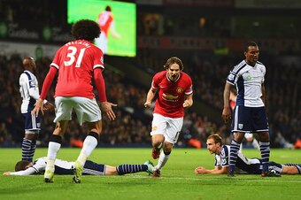 WEST BROMWICH, ENGLAND - OCTOBER 20:  West Bromwich Albion defenders look dejected as Daley Blind of Manchester United (17) celebrates scoring their second and equalising goal with Marouane Fellaini during the Barclays Premier League match between West Br