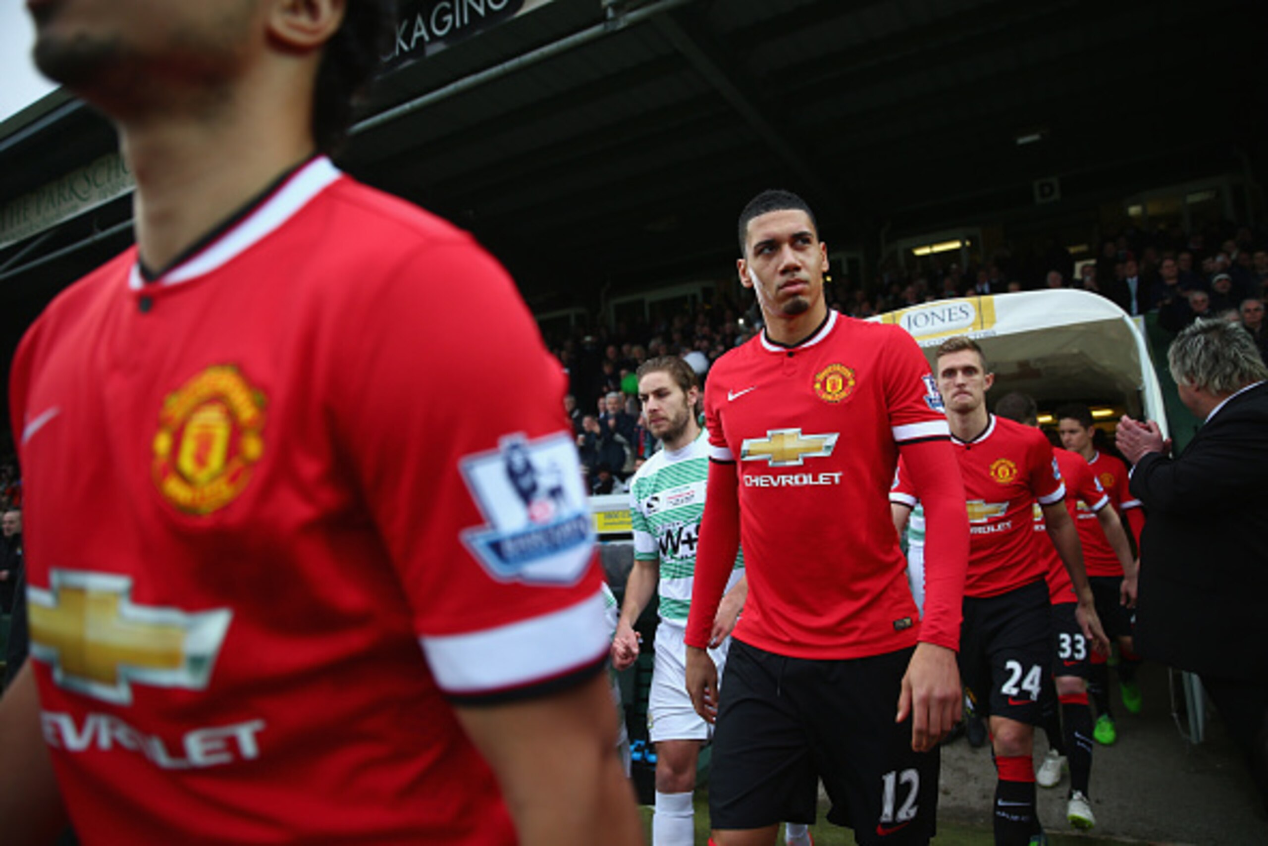 YEOVIL, ENGLAND - JANUARY 04:  Chris Smalling of Manchester United looks towards the travelling support as the teams enter the field of play during the FA Cup Third Round match between Yeovil Town and Manchester United at Huish Park on January 4, 2015 in 