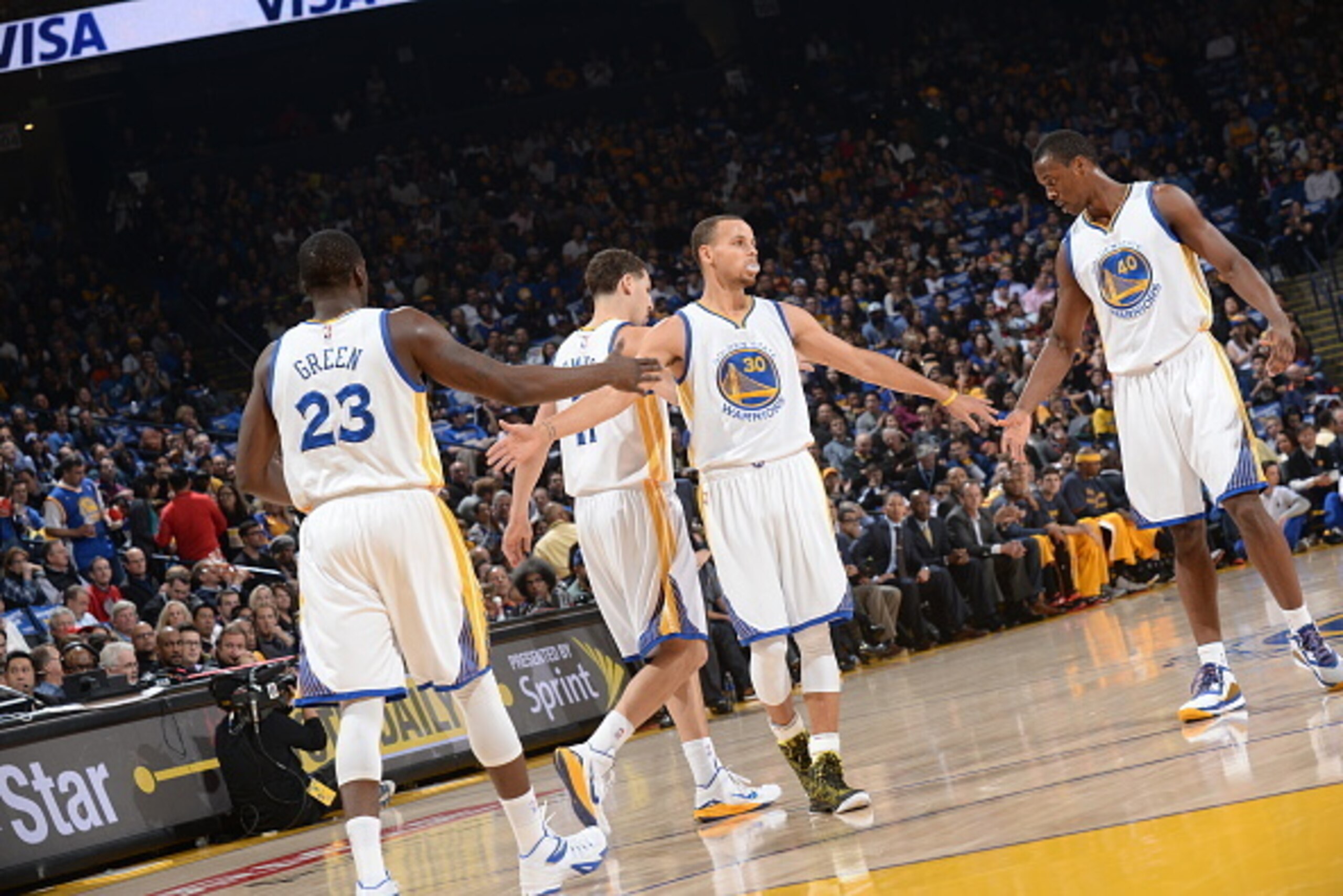 OAKLAND, CA - JANUARY 9: Draymond Green #23 Stephen Curry #30 and Harrison Barnes #40 of the Golden State Warriors celebrate during the game against the Cleveland Cavaliers on January 9, 2015 at Oracle Arena in Oakland, California. NOTE TO USER: User expr