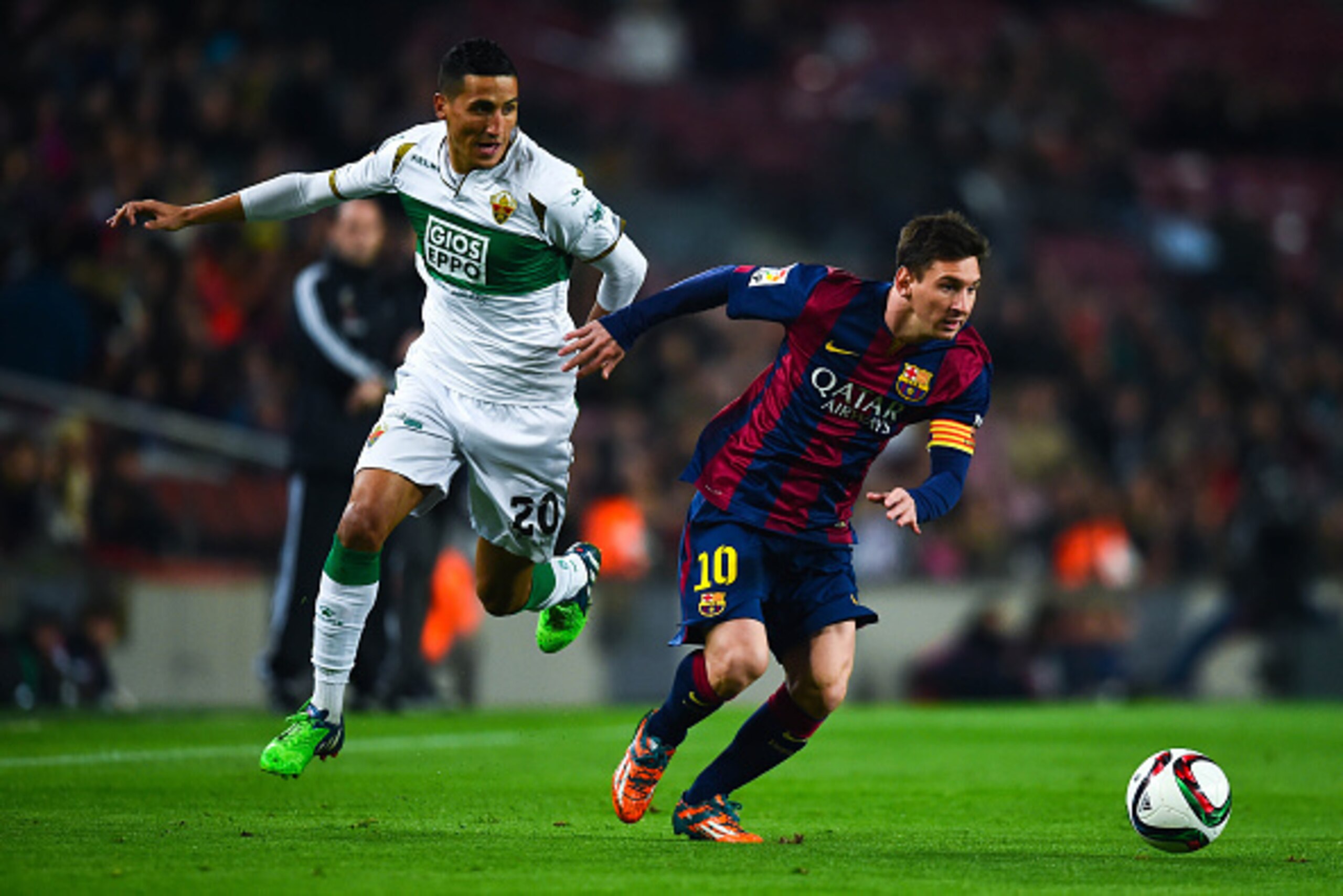 BARCELONA, SPAIN - JANUARY 08:  Lionel Messi of FC Barcelona competes for the ball with Fzycal Fajr of Elche FC during the Copa del Rey  Round of 16 First Leg match between FC Barcelona and Elche CF at Camp Nou on January 8, 2015 in Barcelona, Spain.  (Ph