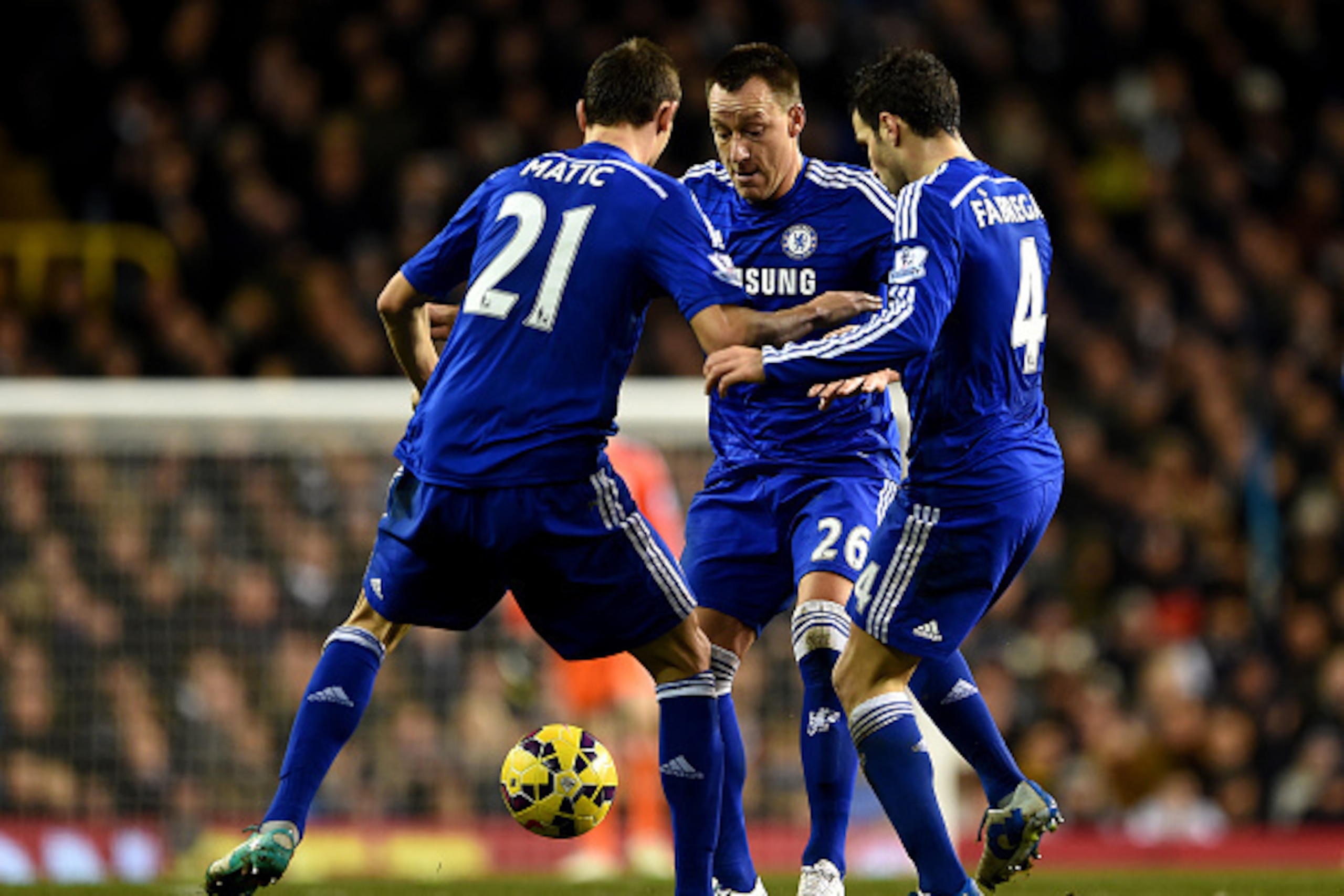 LONDON, ENGLAND - JANUARY 01:  John Terry, Nemanja Matic and Cesc Fabregas of Chelsea fight each other for the ball during the Barclays Premier League match between Tottenham Hotspur and Chelsea at White Hart Lane on January 1, 2015 in London, England.  (