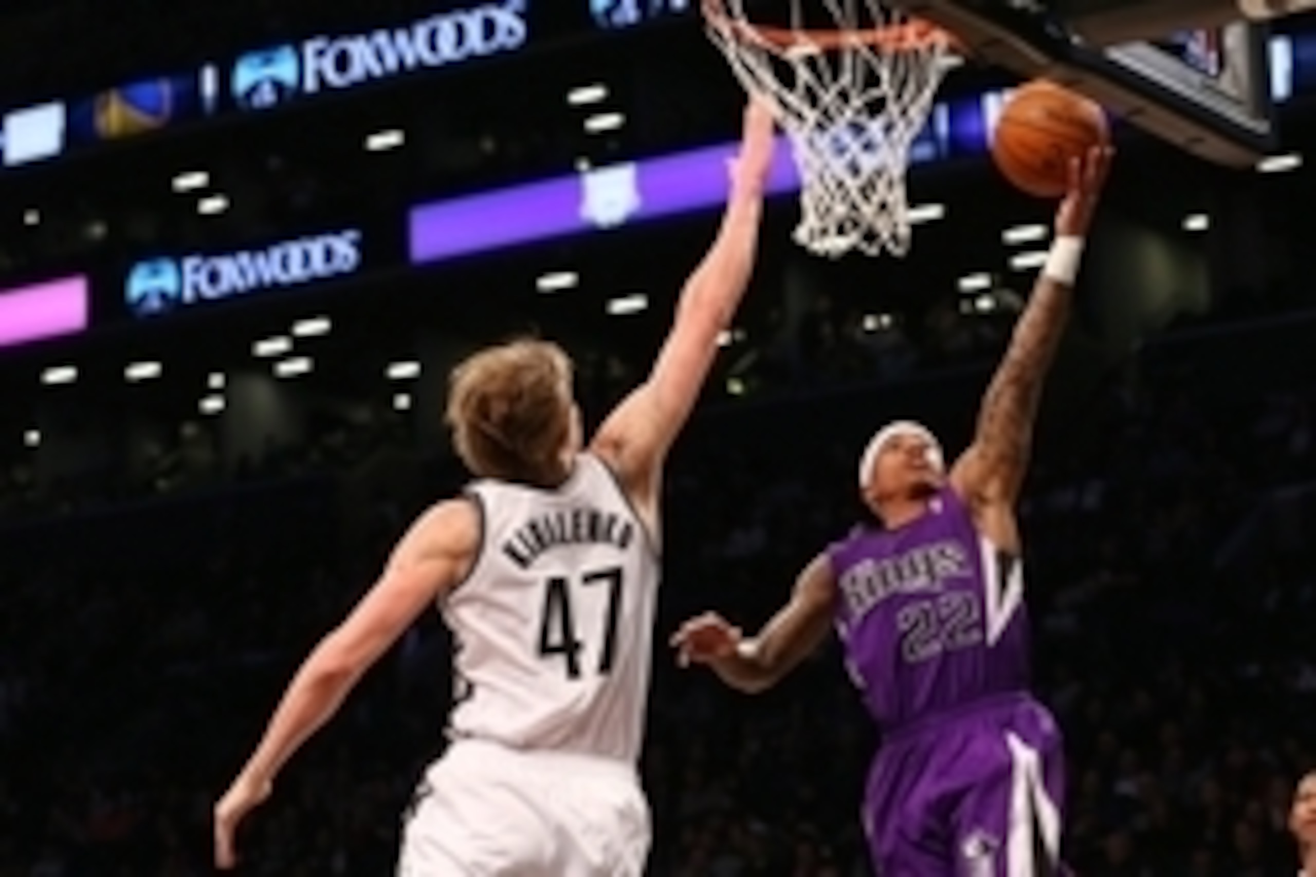 Mar 9, 2014; Brooklyn, NY, USA;  Sacramento Kings point guard Isaiah Thomas (22) puts a shot over Brooklyn Nets small forward Andrei Kirilenko (47) during the first quarter at Barclays Center. Mandatory Credit: Anthony Gruppuso-USA TODAY Sports