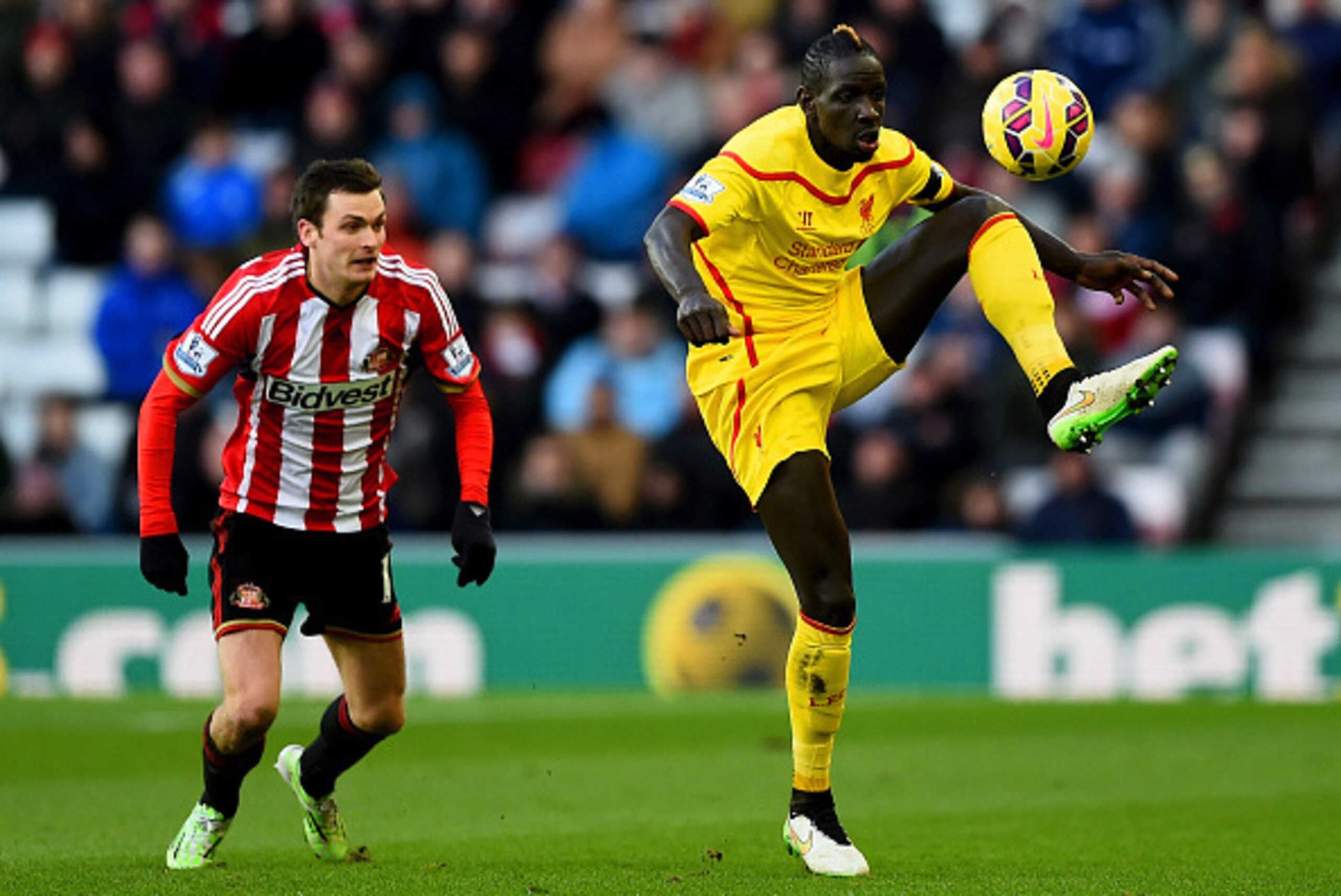 SUNDERLAND, ENGLAND - JANUARY 10:  Mamadou Sakho of Liverpool wears a black armband, in honour of the victims of the Charlie Hebdo attack in Paris, as he controls the ball next to Adam Johnson of Sunderland during the Barclays Premier League match between
