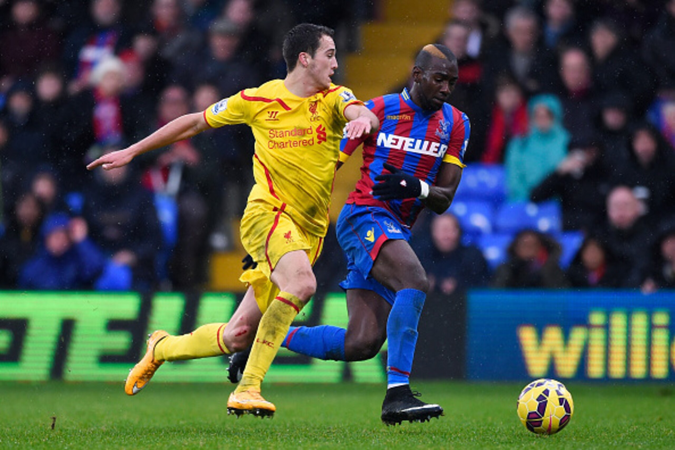 LONDON, ENGLAND - NOVEMBER 23: Yannick Bolasie of Crystal Palace is closed down by Javi Manquillo of Liverpool during the Barclays Premier League match between Crystal Palace and Liverpool at Selhurst Park on November 23, 2014 in London, England.  (Photo 