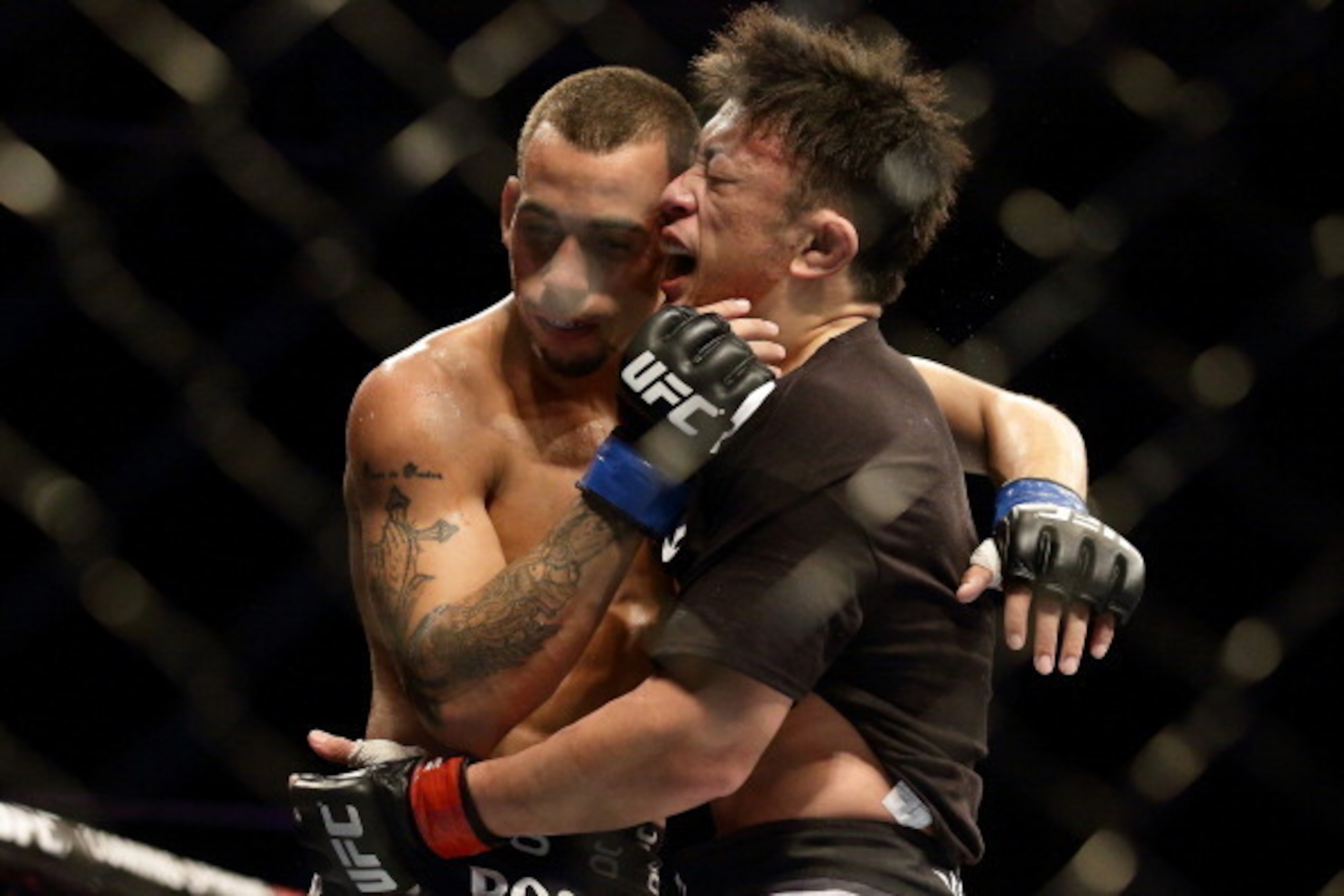 SINGAPORE - JANUARY 04:  Tatsuya Kawajiri (R) and Sean Soriano share a hug at the end of  their UFC Fight Night Singapore featherweight bout at Marina Bay Sands on January 4, 2014 in Singapore.  (Photo by Suhaimi Abdullah/Getty Images)