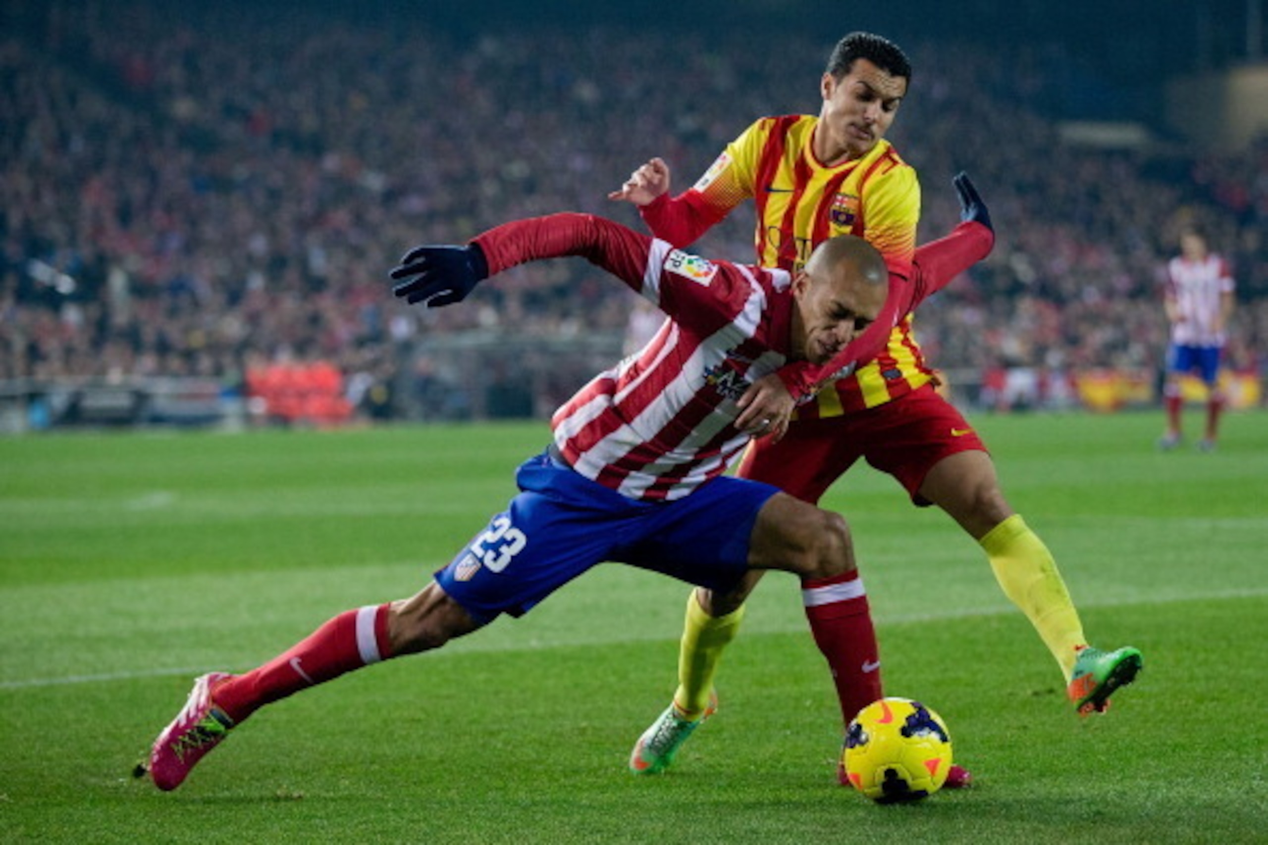 MADRID, SPAIN - JANUARY 11:  Pedro Rodriguez Ledesma (R) of FC Barcelona competes for the ball with Joao Miranda (L) of Atletico de Madrid during the La Liga match between Club Atletico de Madrid and FC Barcelona at Vicente Calderon Stadium on January 11,