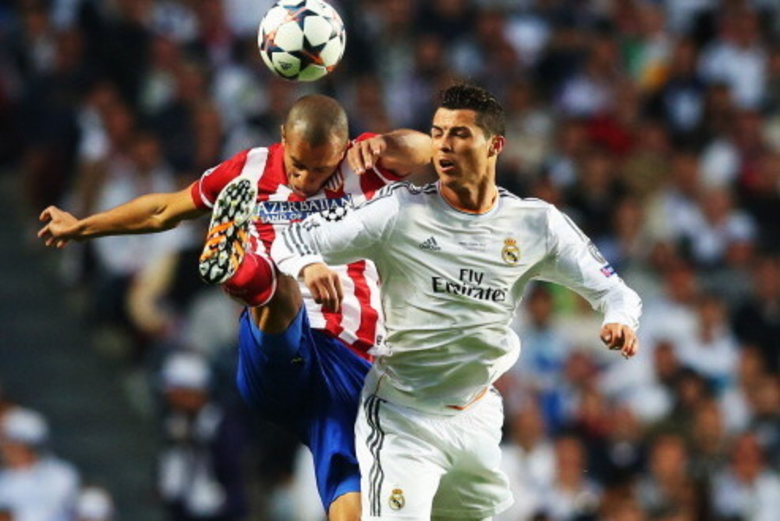 LISBON, PORTUGAL - MAY 24:  Miranda of Club Atletico de Madrid jumps with Cristiano Ronaldo of Real Madrid during the UEFA Champions League Final between Real Madrid and Atletico de Madrid at Estadio da Luz on May 24, 2014 in Lisbon, Portugal.  (Photo by 