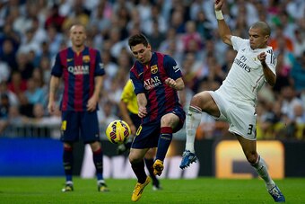 MADRID, SPAIN - OCTOBER 25: Lionel Messi (L) of FC Barcelona competes for the ball with Pepe (R) of Real Madrid CF during the La Liga match between Real Madrid CF and FC Barcelona at Estadio Santiago Bernabeu on October 25, 2014 in Madrid, Spain.  (Photo 