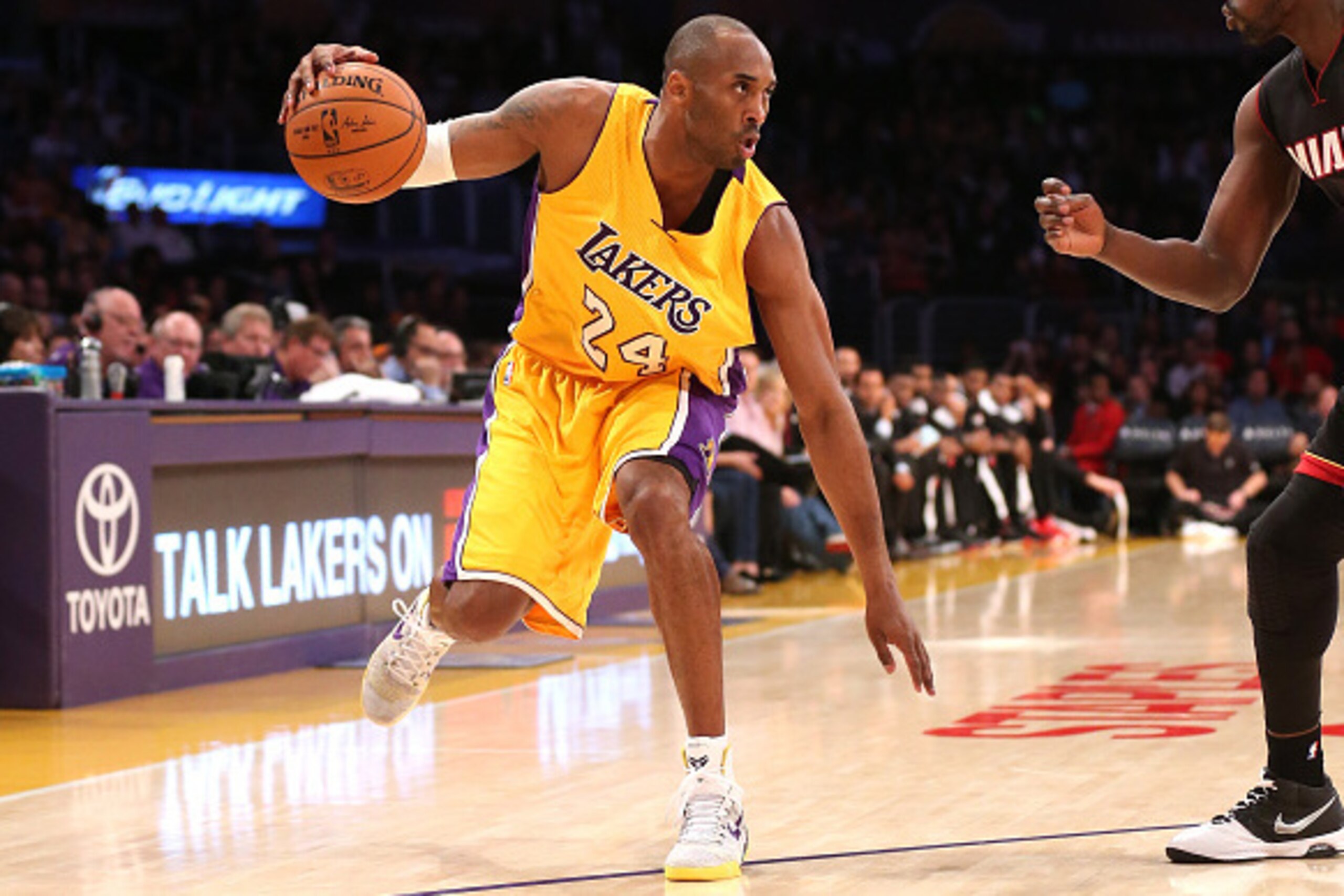 LOS ANGELES, CA - JANUARY 13:  Kobe Bryant #24 of the Los Angeles Lakers controls the ball against Luol Deng #9 of the Miami Heat at Staples Center on January 13, 2015 in Los Angeles, California.  NOTE TO USER: User expressly acknowledges and agrees that,