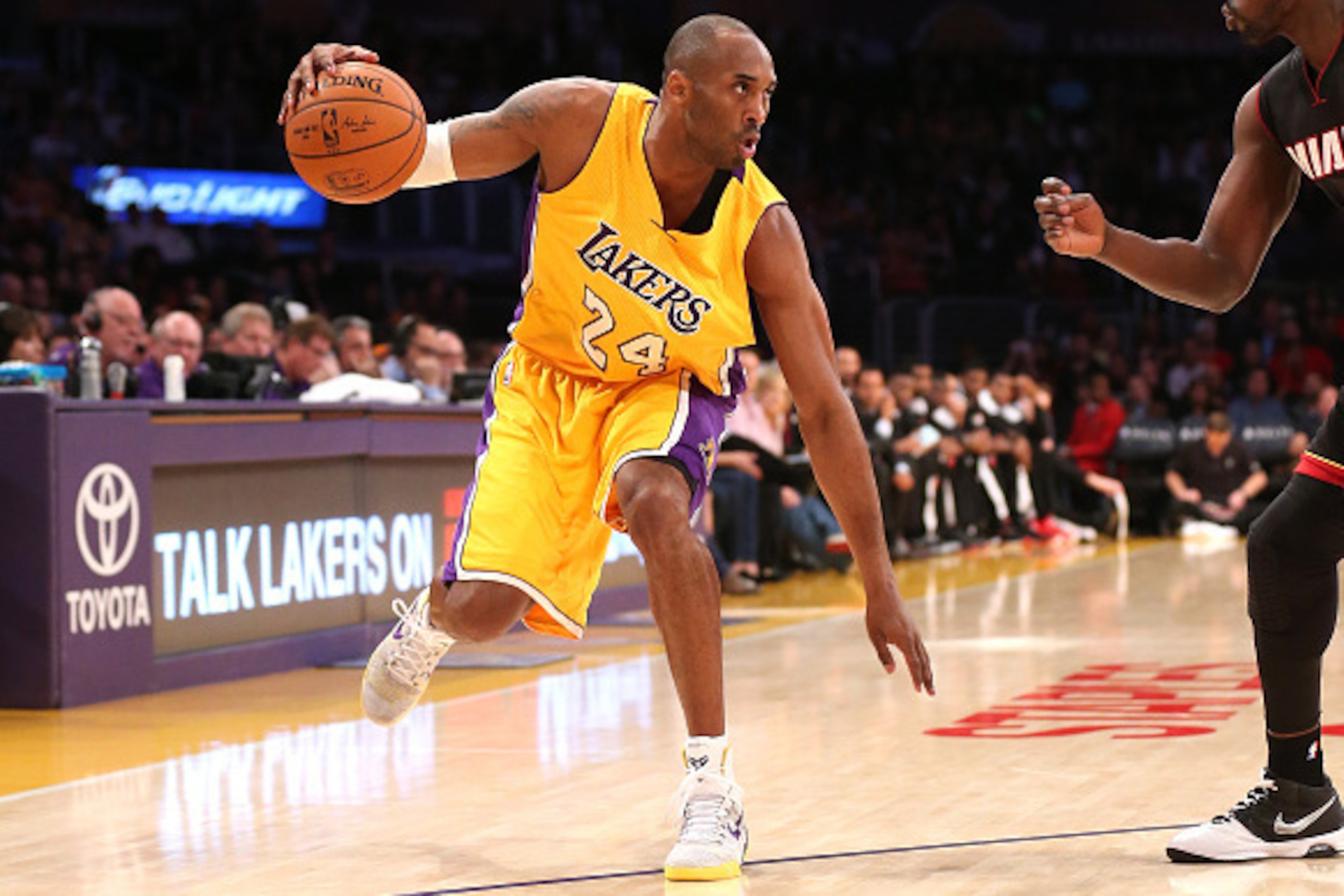 LOS ANGELES, CA - JANUARY 13:  Kobe Bryant #24 of the Los Angeles Lakers controls the ball against Luol Deng #9 of the Miami Heat at Staples Center on January 13, 2015 in Los Angeles, California.  NOTE TO USER: User expressly acknowledges and agrees that,