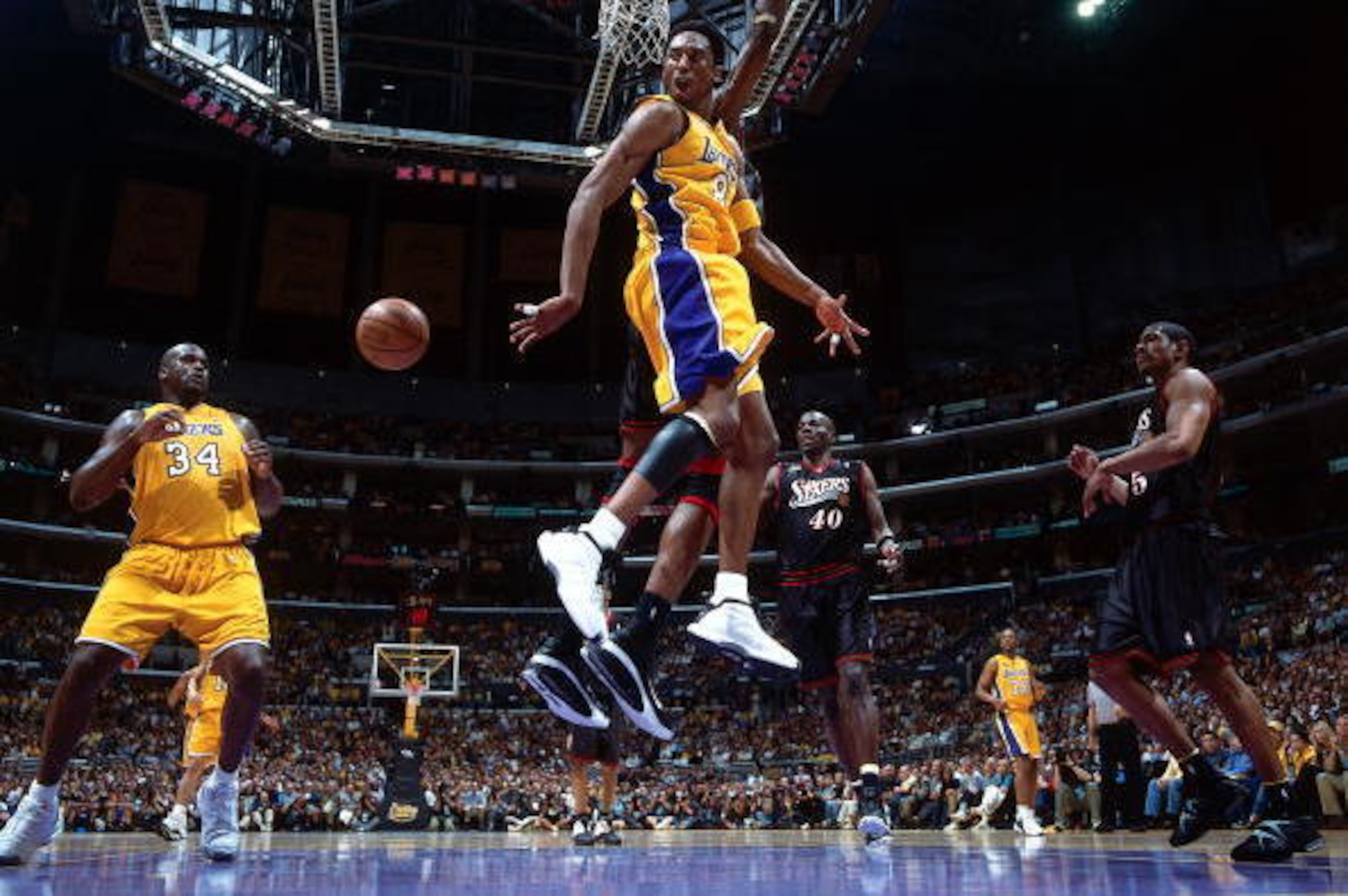 LOS ANGELES - JUNE 6:  Kobe Bryant #8 passes to teammate Shaquille O'Neal #34 of the Los Angeles Lakers during Game one of the 2001 NBA Finals against the Philadelphia 76ers played on June 6, 2001 at Staples Center in Los Angeles, California.  NOTE TO USE