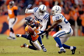 DENVER, CO - JANUARY 11:  Wes Welker #83 of the Denver Broncos attempts to make a catch as Darius Butler #20 of the Indianapolis Colts defends during a 2015 AFC Divisional Playoff game at Sports Authority Field at Mile High on January 11, 2015 in Denver,