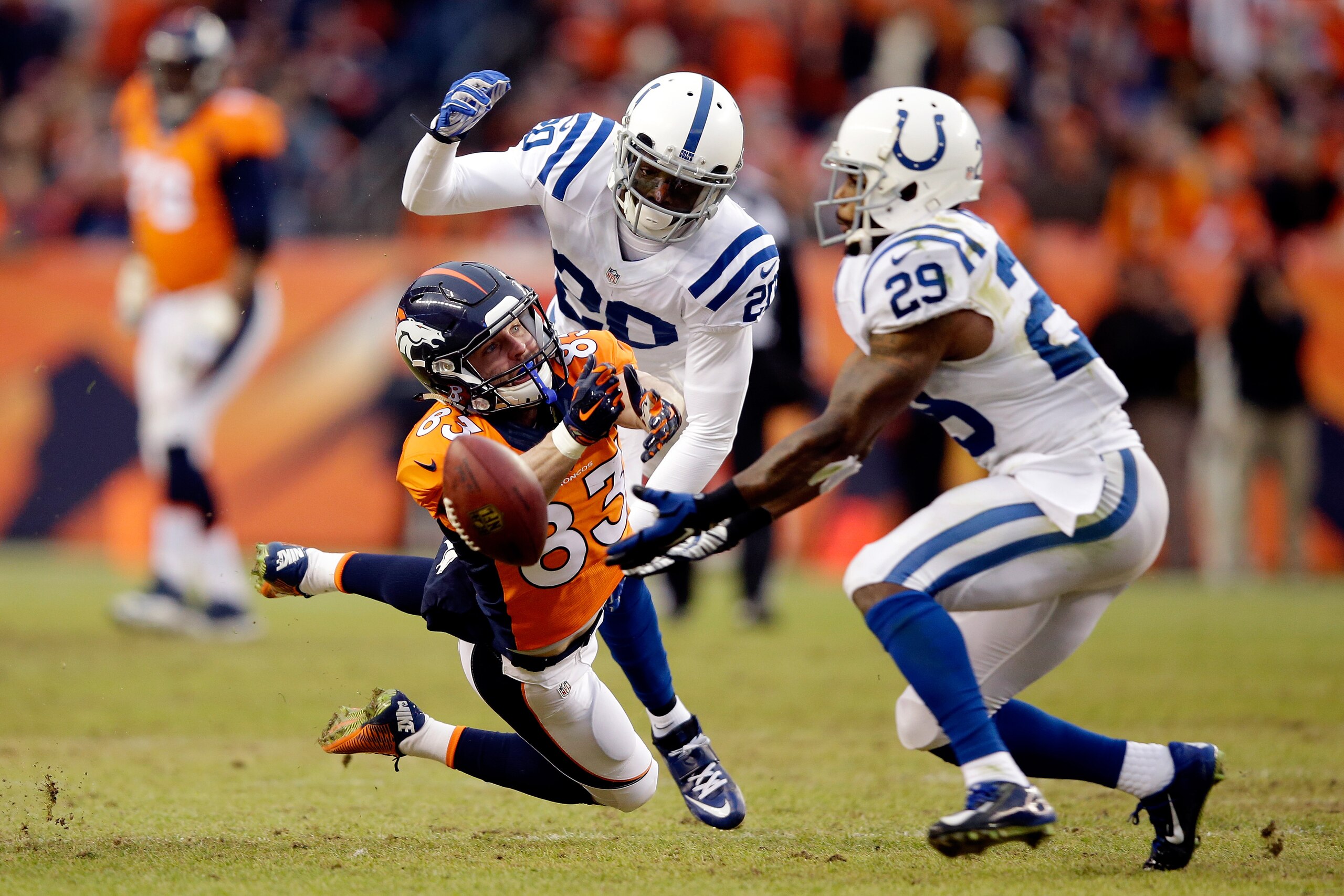 DENVER, CO - JANUARY 11:  Wes Welker #83 of the Denver Broncos attempts to make a catch as Darius Butler #20 of the Indianapolis Colts defends during a 2015 AFC Divisional Playoff game at Sports Authority Field at Mile High on January 11, 2015 in Denver,