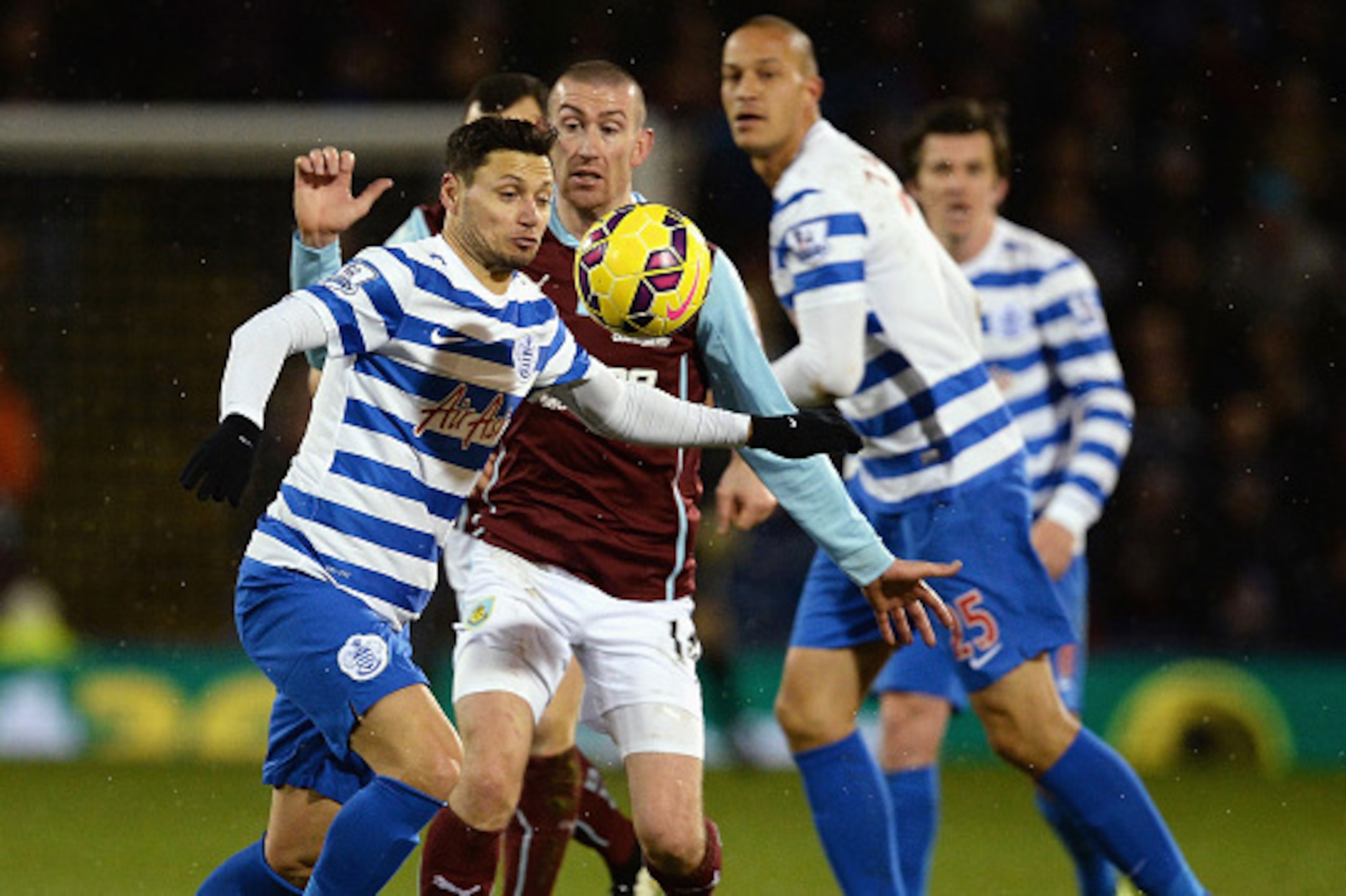 BURNLEY, ENGLAND - JANUARY 10:  Mauro Zarate of QPR is challenged by David Jones of Burnley during the Barclays Premier League match between Burnley and Queens Park Rangers at Turf Moor on January 10, 2015 in Burnley, England.  (Photo by Nigel Roddis/Gett