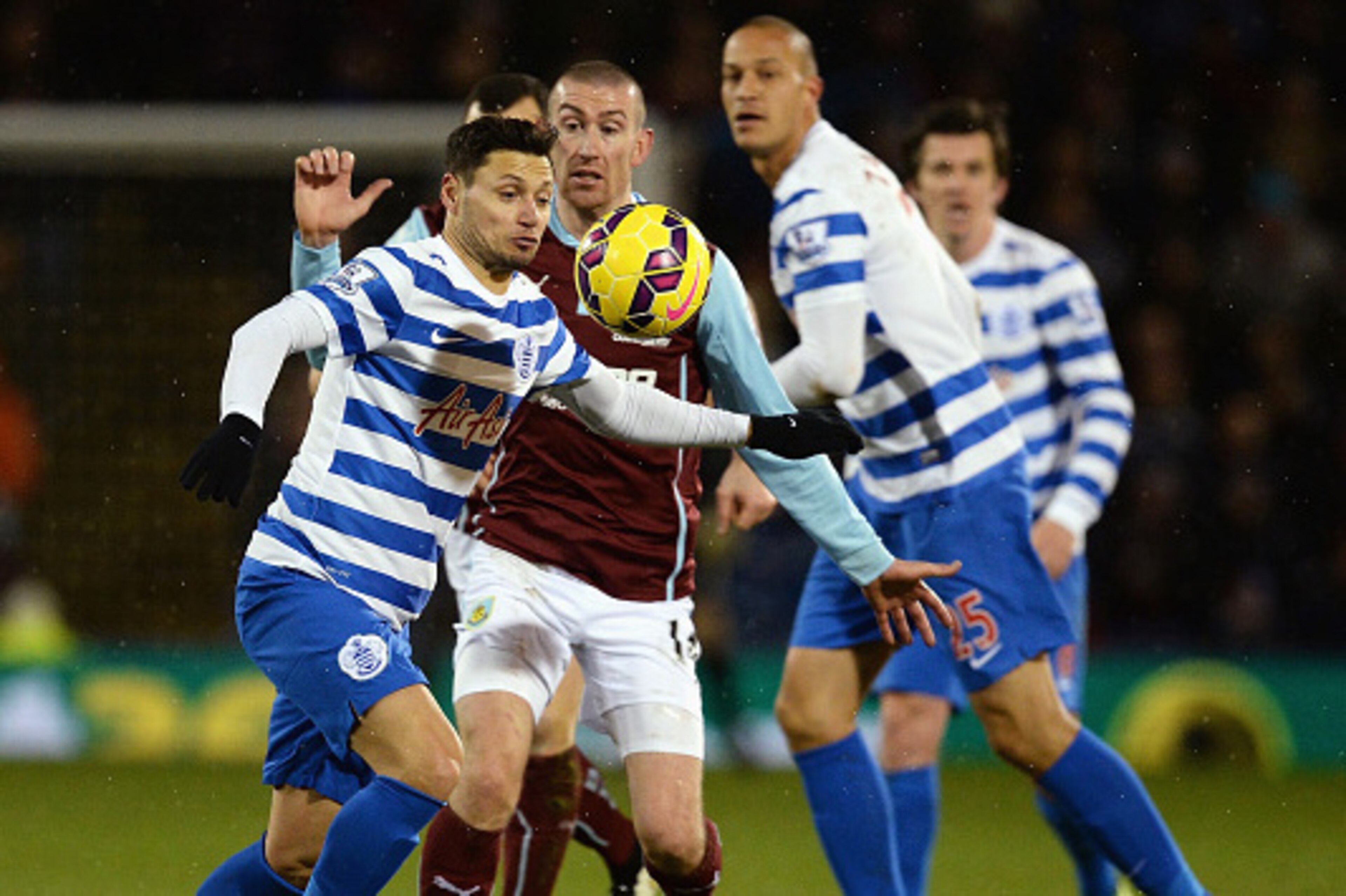 BURNLEY, ENGLAND - JANUARY 10:  Mauro Zarate of QPR is challenged by David Jones of Burnley during the Barclays Premier League match between Burnley and Queens Park Rangers at Turf Moor on January 10, 2015 in Burnley, England.  (Photo by Nigel Roddis/Gett