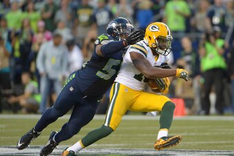 Sep 4, 2014; Seattle, WA, USA; Seattle Seahawks linebacker Bobby Wagner (54) tackles Green Bay Packers receiver Randall Cobb (18) at CenturyLink Field. The Seahawks defeated the Packers 36-16. Mandatory Credit: Kirby Lee-USA TODAY Sports