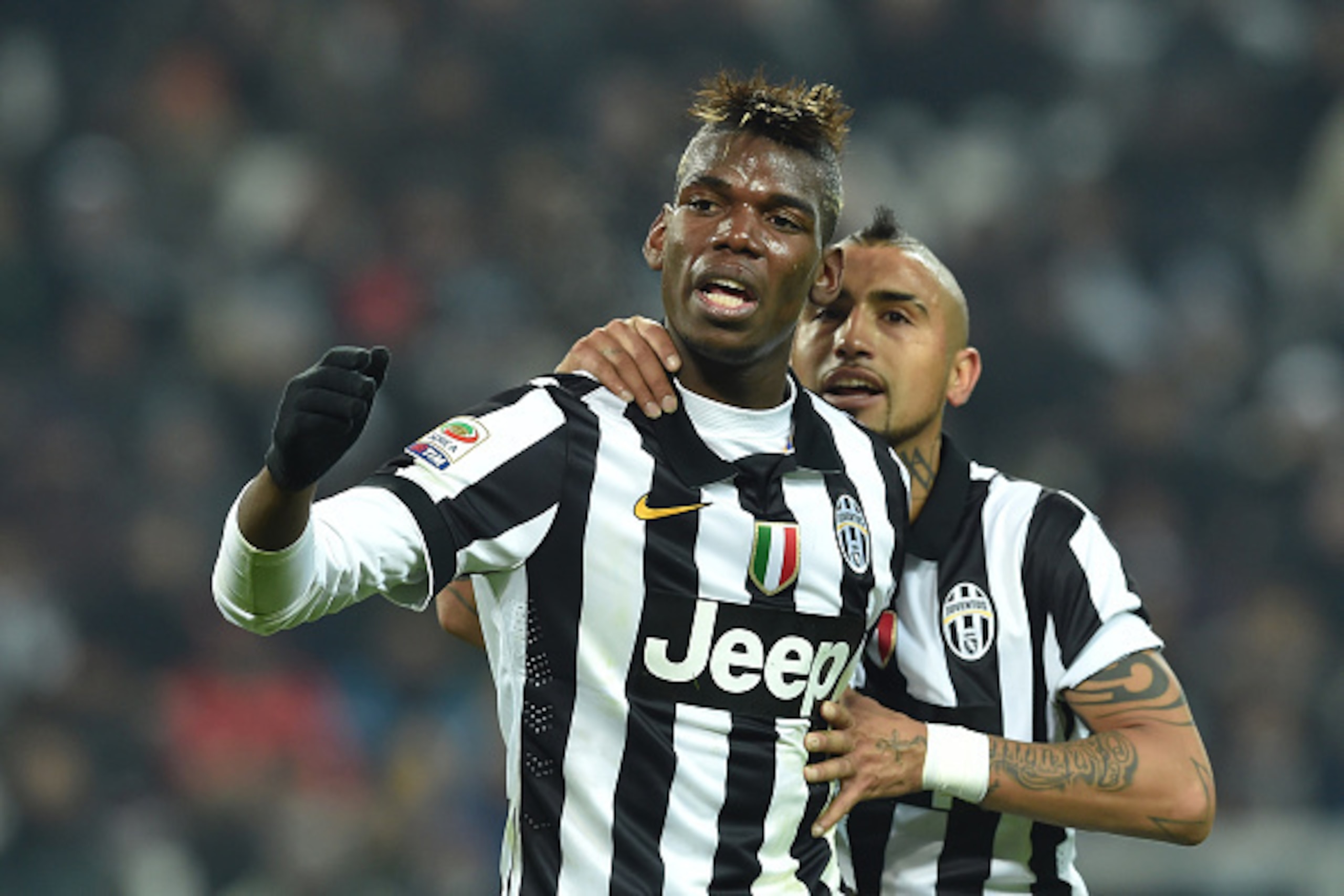 TURIN, ITALY - JANUARY 06:  Paul Pogba (L) of Juventus FC reacts during the Serie A match between Juventus FC and FC Internazionale Milano at Juventus Arena on January 6, 2015 in Turin, Italy.  (Photo by Valerio Pennicino/Getty Images)
