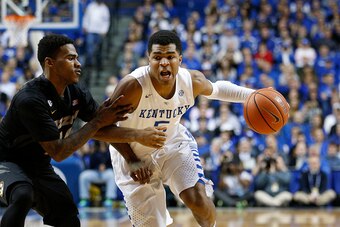 LEXINGTON, KY - JANUARY 13: Andrew Harrison #5 of the Kentucky Wildcats drives to the basket against Keith Shamburger #14 of the Missouri Tigers during the game at Rupp Arena on January 13, 2015 in Lexington, Kentucky. Kentucky defeated Missouri 86-37. (P