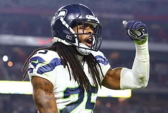 Dec 21, 2014; Glendale, AZ, USA; Seattle Seahawks cornerback Richard Sherman (25) celebrates his fourth quarter interception against the Arizona Cardinals at University of Phoenix Stadium. The Seahawks defeated the Cardinals 35-6. Mandatory Credit: Mark J