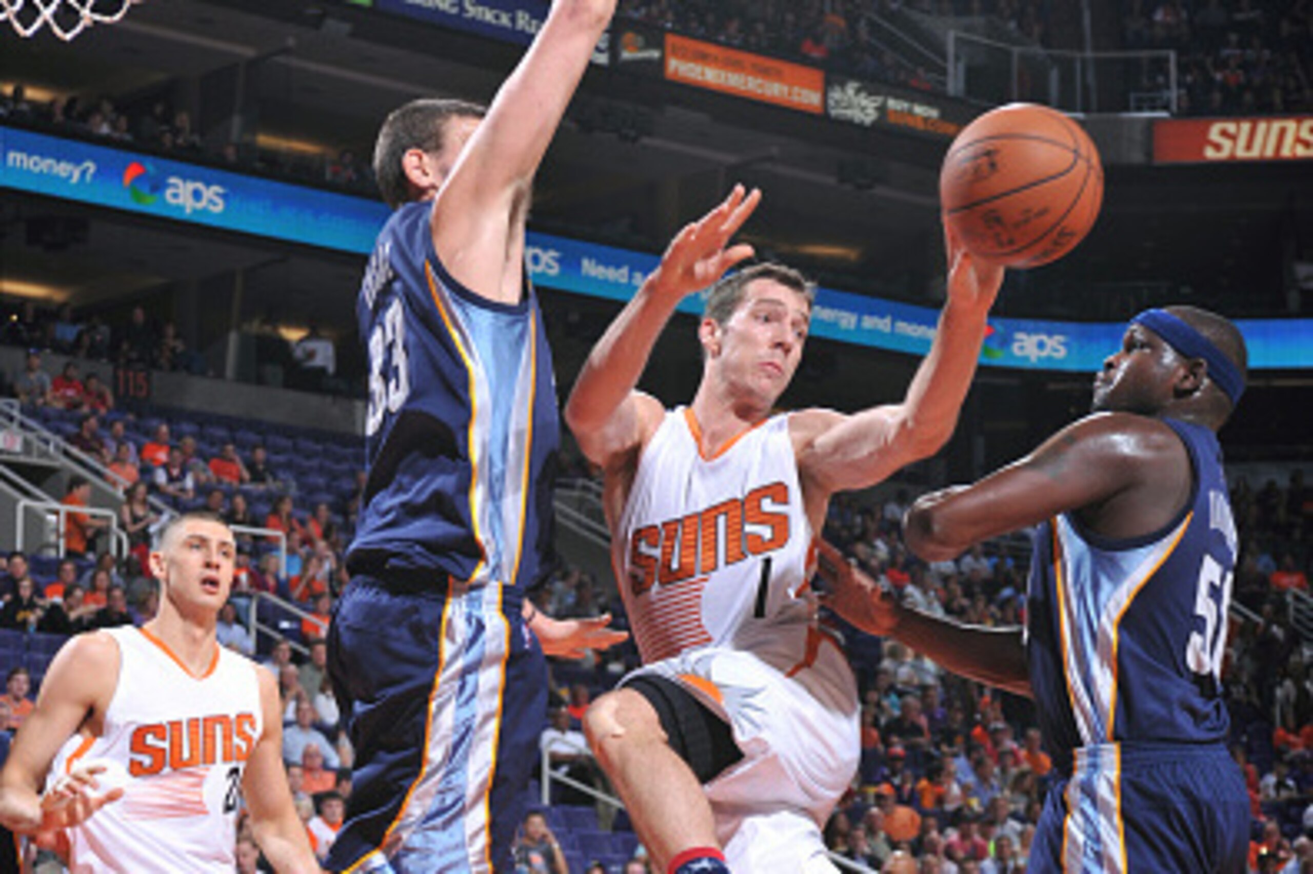 PHOENIX, AZ - NOVEMBER 5: Goran Dragic #1 of the Phoenix Suns makes a pass between Marc Gasol #33 and Zach Randolph #50 of the Memphis Grizzlies on November 5, 2014 at U.S. Airways Center in Phoenix, Arizona. NOTE TO USER: User expressly acknowledges and 