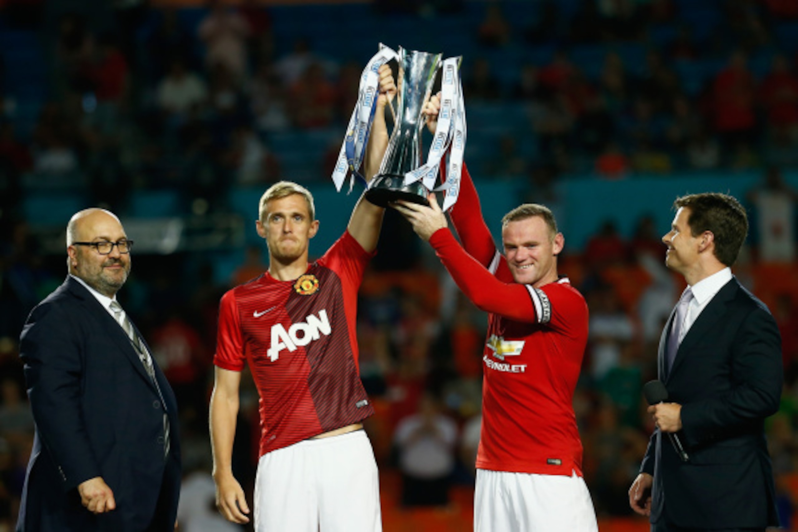 MIAMI GARDENS, FL - AUGUST 04: (L) Darren Fletcher #24 of Manchester United and (R) Wayne Rooney #10 of Manchester United lift the trophy following their 3-1 vicotory over Liverpool in the Guinness International Champions Cup 2014 Final at Sun Life Stadiu