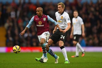 BIRMINGHAM, ENGLAND - DECEMBER 20: Fabian Delph of Aston Villa is marshalled by Darren Fletcher of Manchester United during the Barclays Premier League match between Aston Villa and Manchester United at Villa Park on December 20, 2014 in Birmingham, Engla