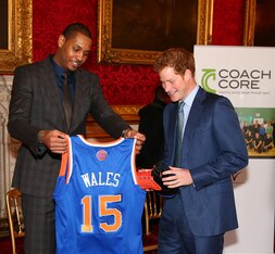 LONDON, ENGLAND - JANUARY 14:  Carmelo Anthony of the New York Knicks presents a jersey and sneakers to Prince Harry at the Coach Core graduation ceremony. This event is part of the partnership between the Royal Foundation and the NBA as part of the 2015 