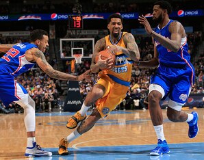 DENVER, CO - DECEMBER 19:  Wilson Chandler #21 of the Denver Nuggets drives to the basket between Matt Barnes #22 of the Los Angeles Clippers and DeAndre Jordan #6 of the Los Angeles Clippers  at Pepsi Center on December 19, 2014 in Denver, Colorado. The 
