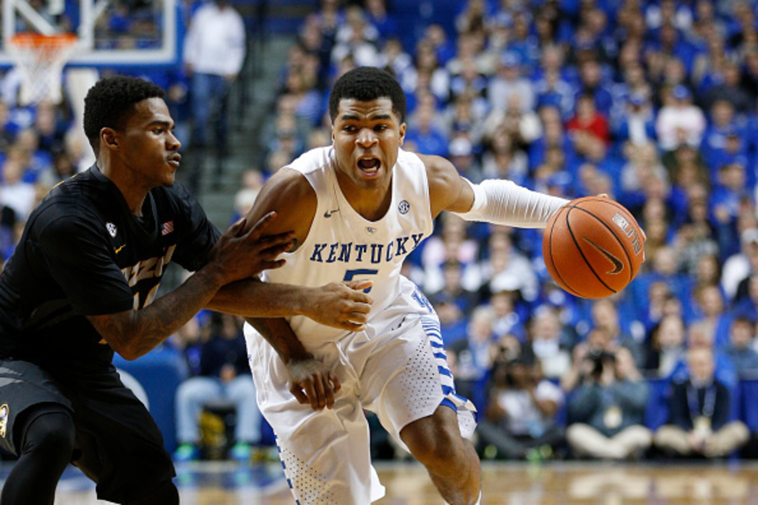 LEXINGTON, KY - JANUARY 13: Andrew Harrison #5 of the Kentucky Wildcats drives to the basket against Keith Shamburger #14 of the Missouri Tigers during the game at Rupp Arena on January 13, 2015 in Lexington, Kentucky. Kentucky defeated Missouri 86-37. (P